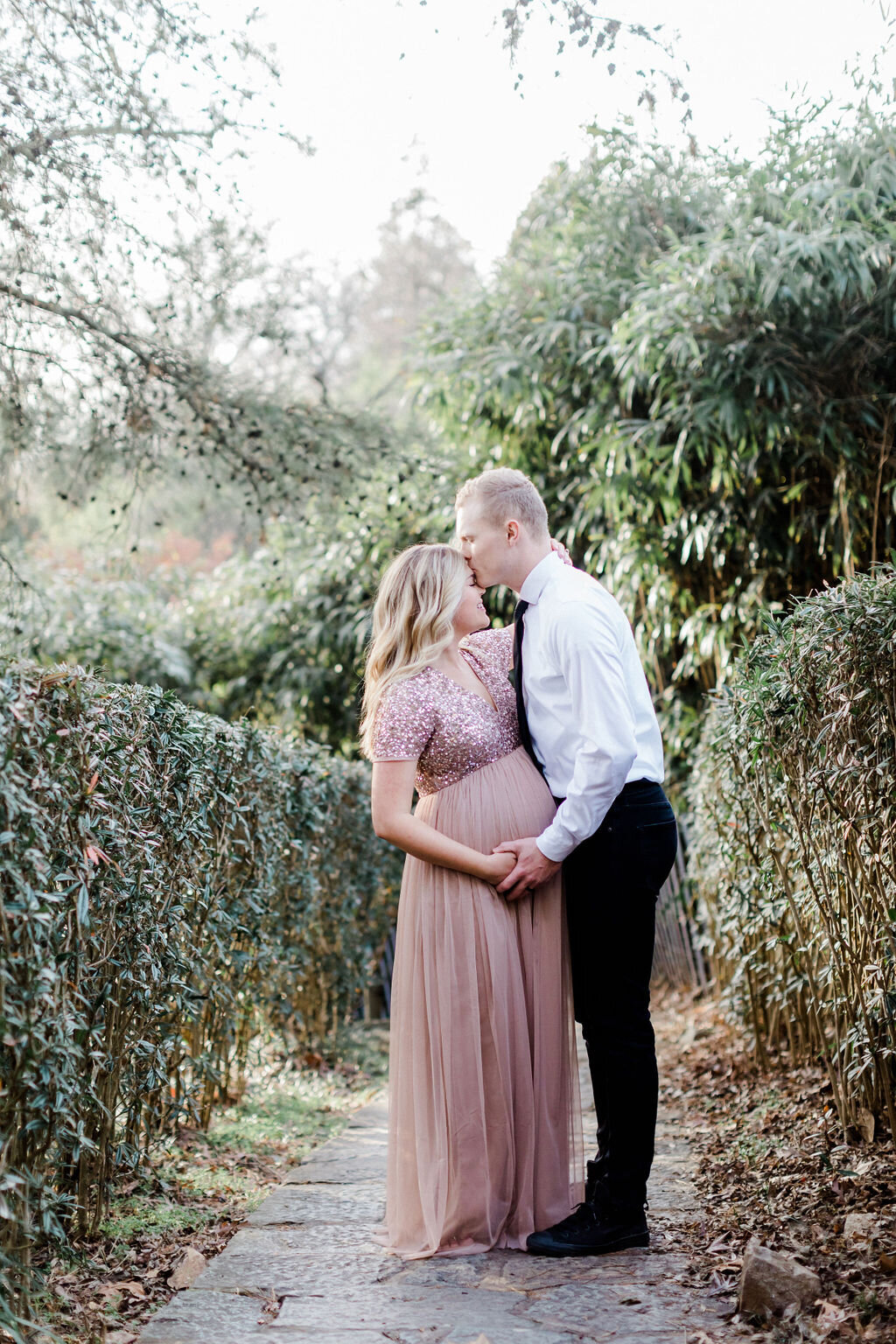 Expectant parents admiringly looking at each other as they anticipate the arrival of their baby boy. This maternity session was taken at Maymont in Richmond, Virginia