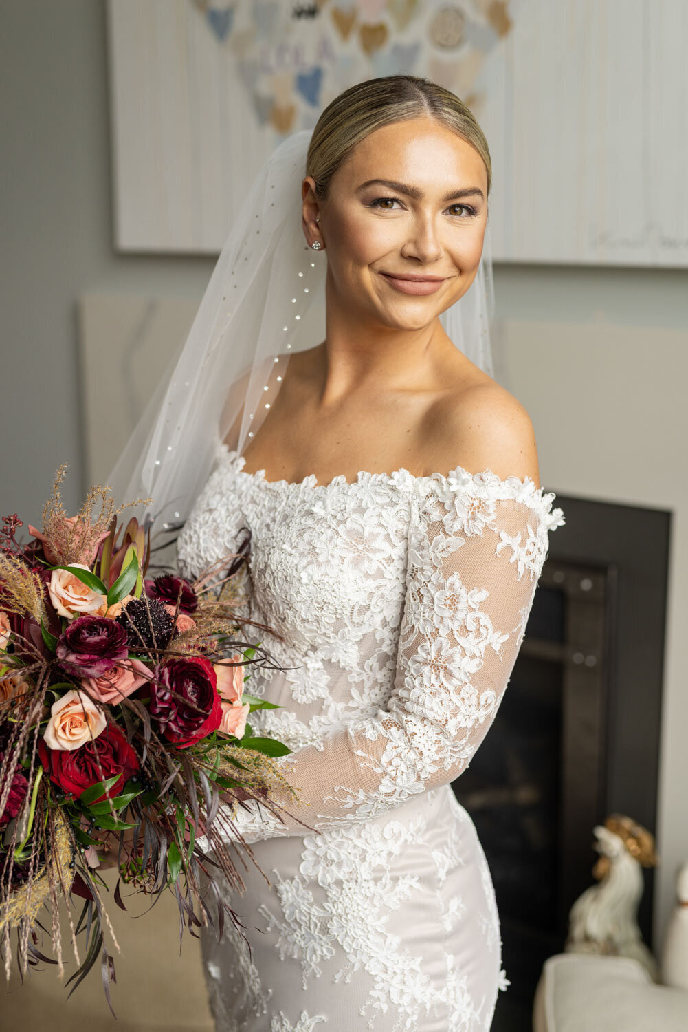 A woman in a wedding dress is holding a bouquet of flowers