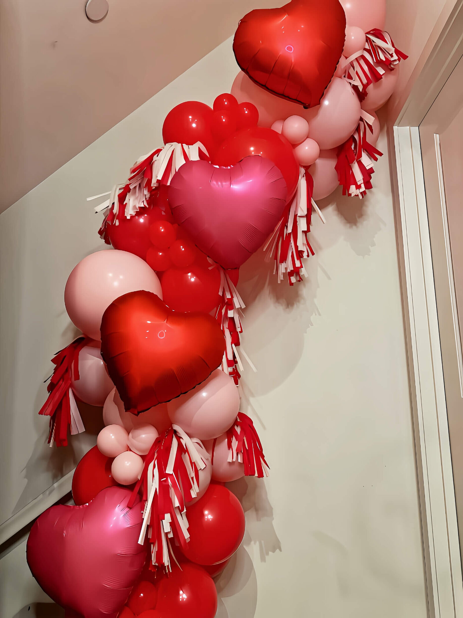 Valentines Day balloon decoration with red and pink balloons
