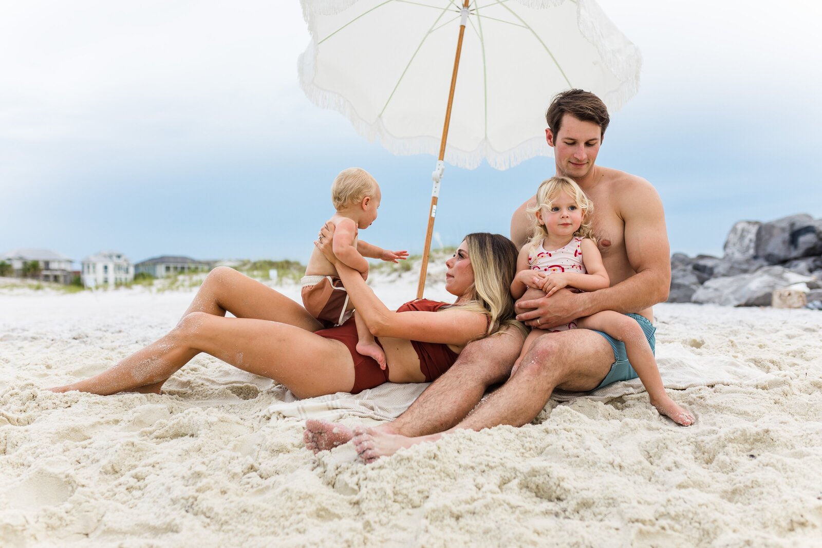 Pensacola Beach vacation family photo session . Family playing in the water.