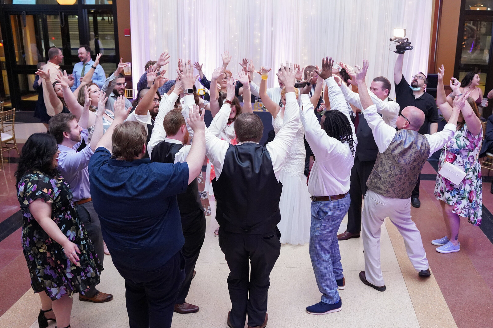 Bride and groom dancing surrounded by friends at Chicago wedding DJ reception