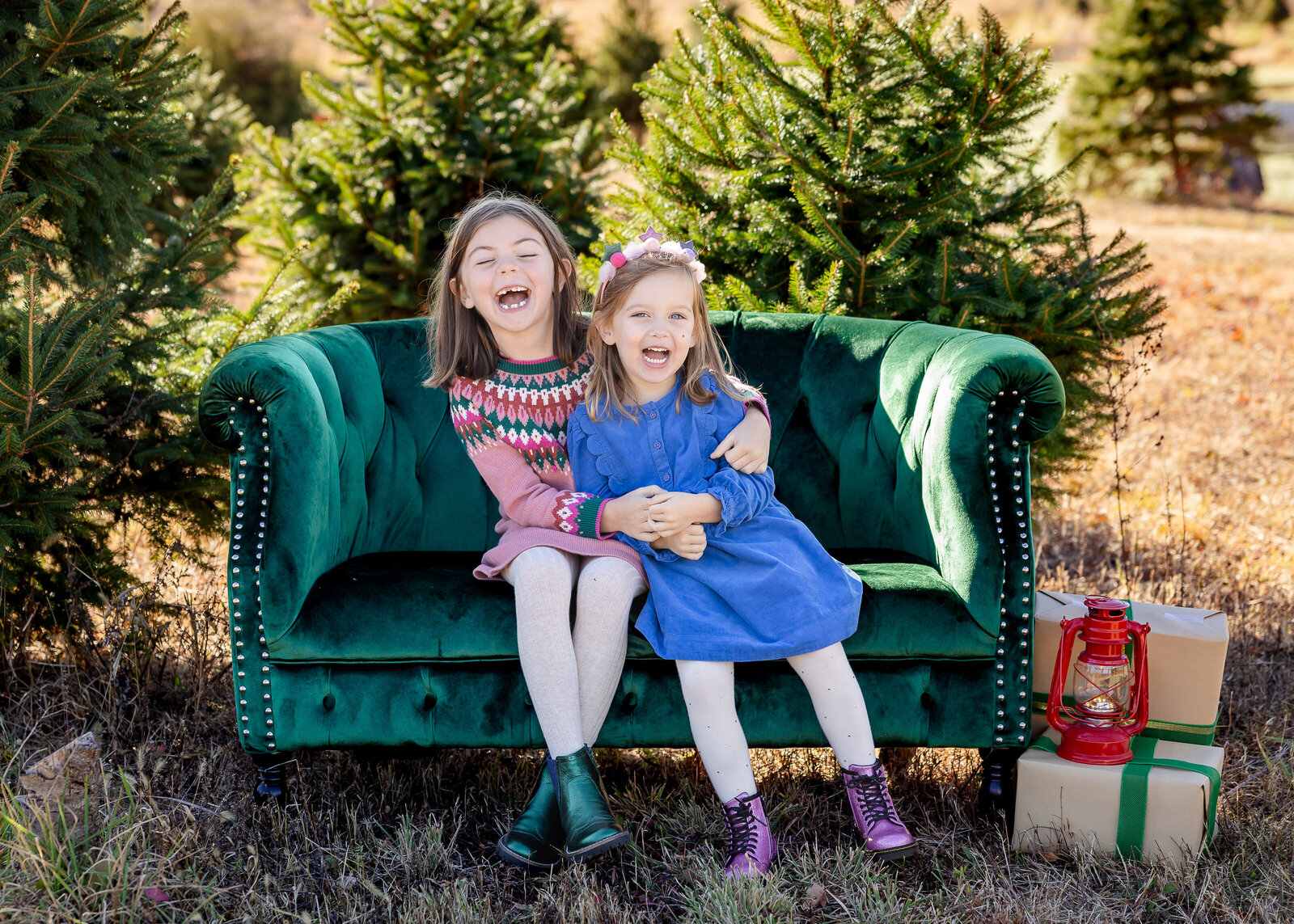Holiday photo of siblings laughing and hugging at a Sussex County, New Jersey Christmas tree farm.