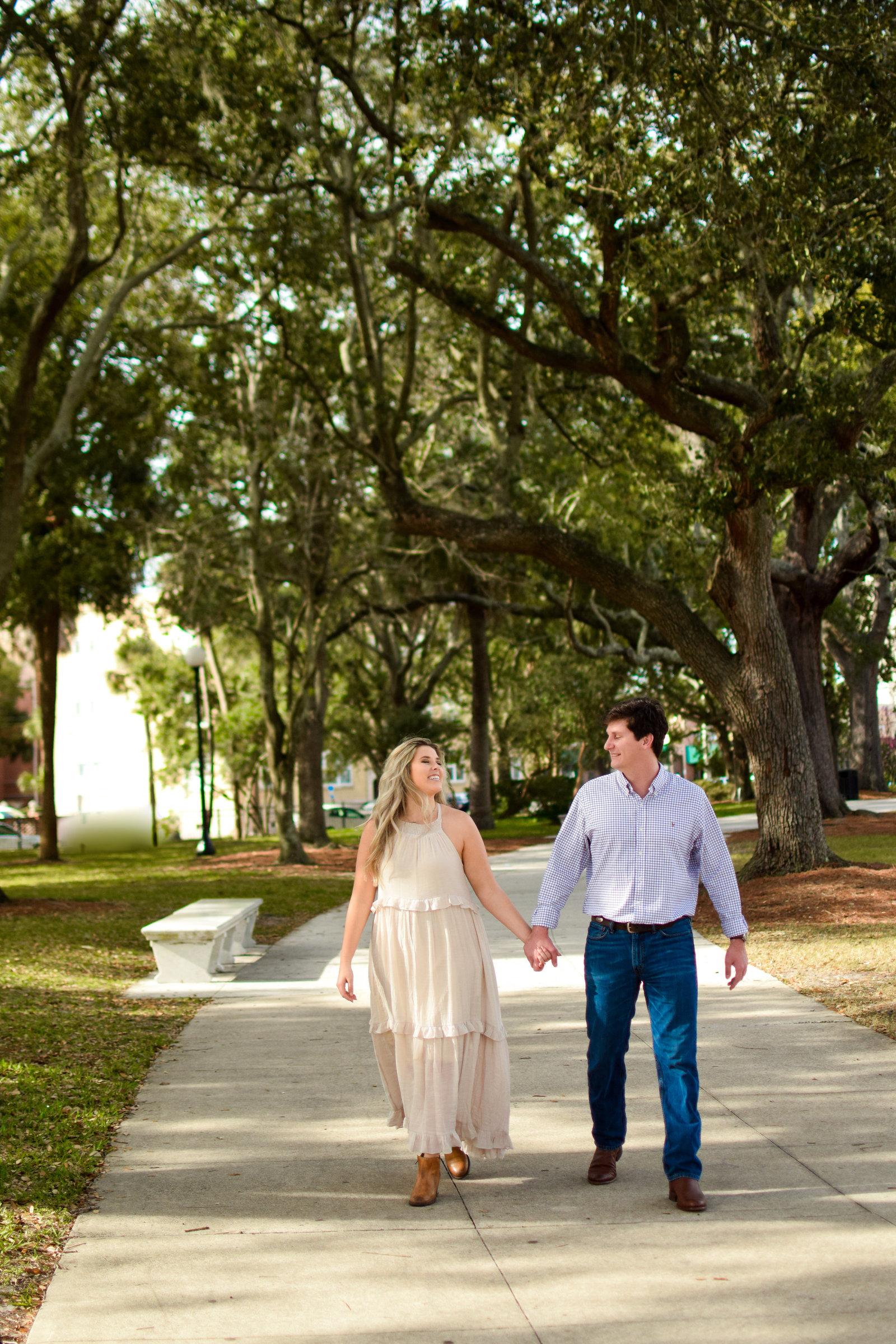 Couple walking engagement park Jacksonville Riverfront Florida