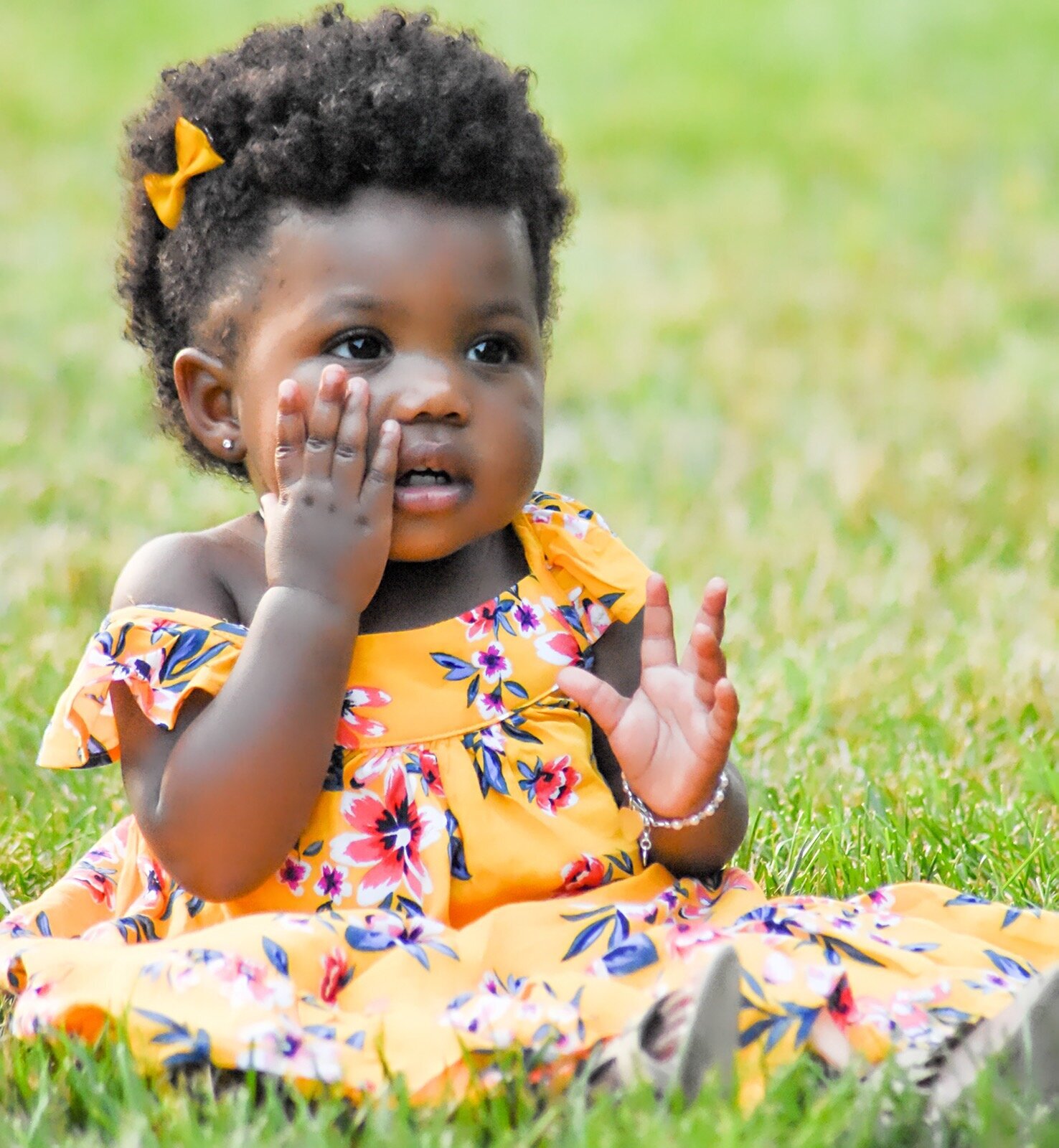 young black girl in a yellow floral dress photographed by Millz Photography in Greenville, SC