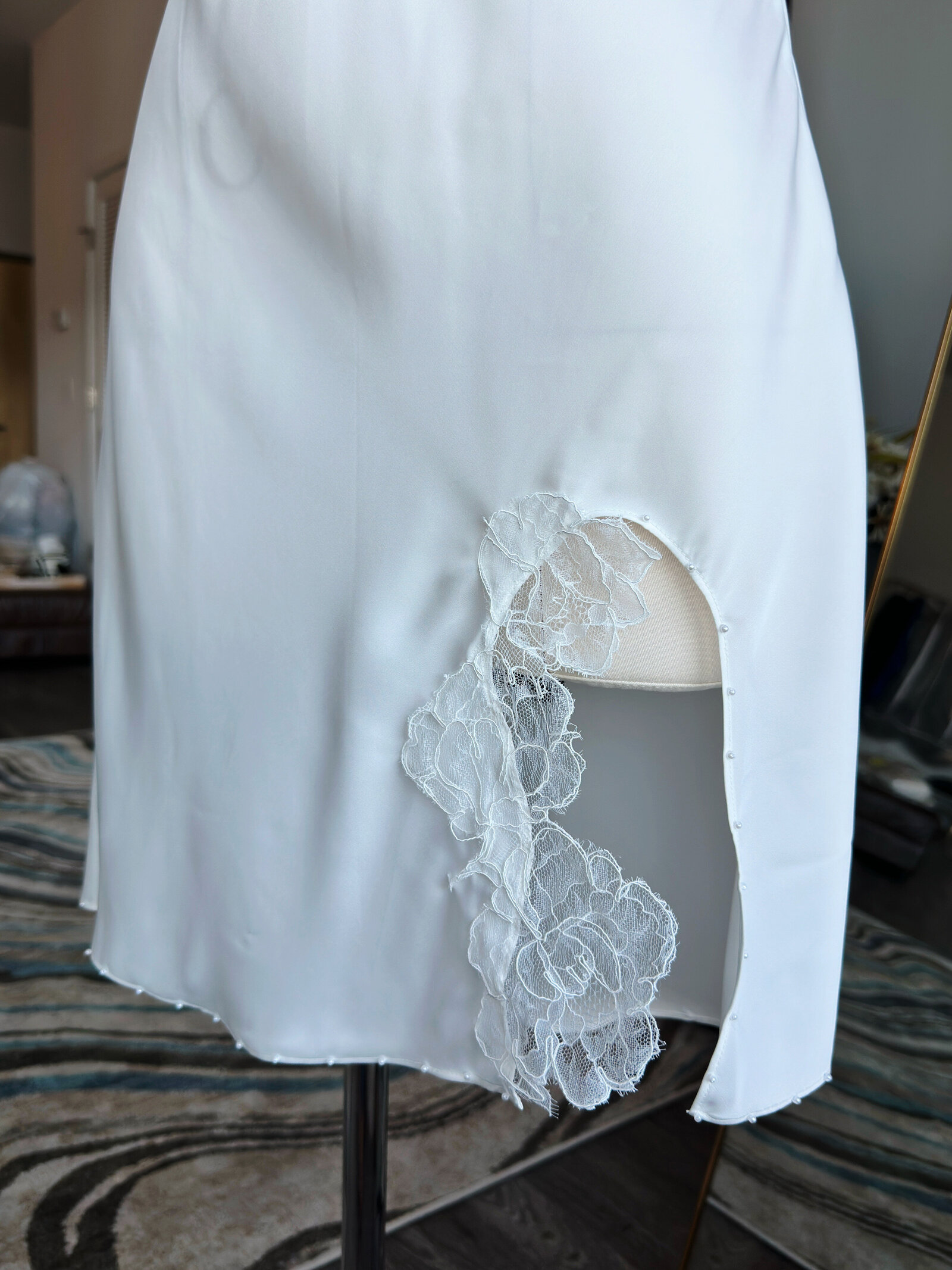 Bride wearing soft silk slip dress with delicate beaded edging
