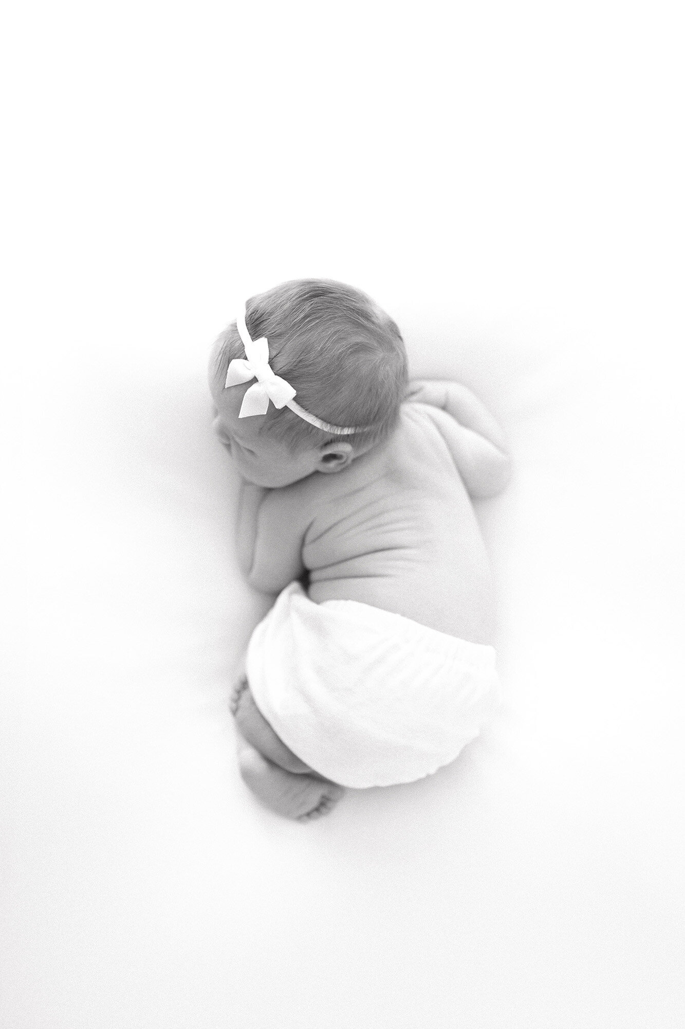 Curled newborn baby on blanket | Grand Forks ND professional newborn photographer