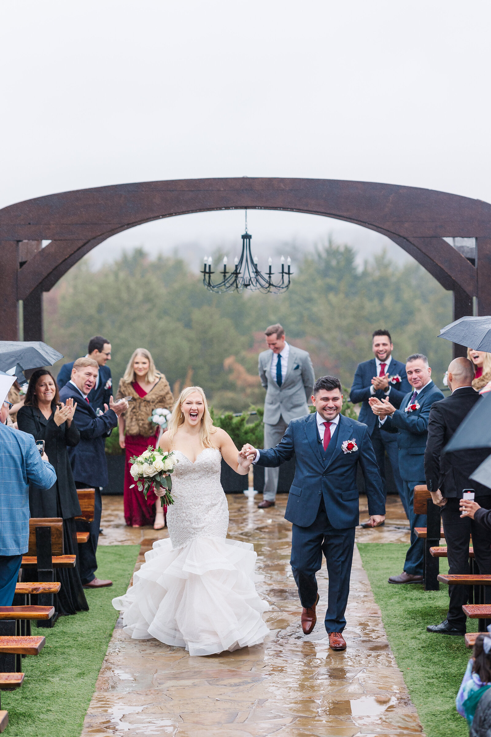 Bride and groom walk after ceremony outdoor photography