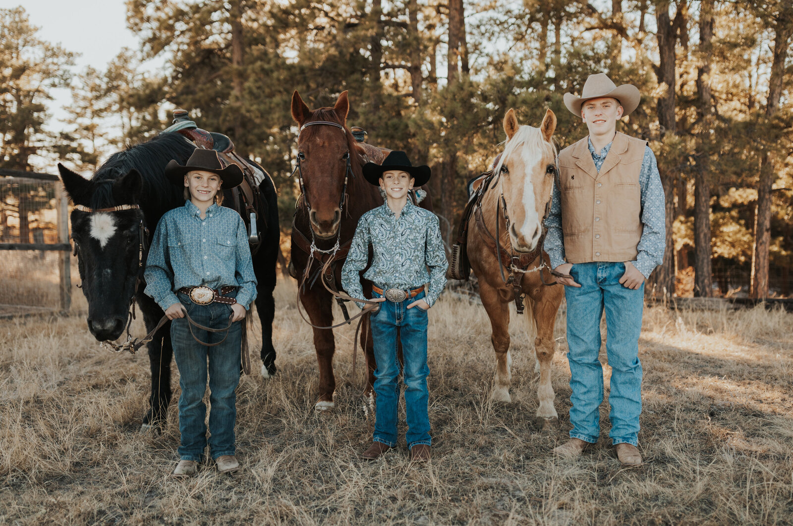 Brothers posing with their horses
