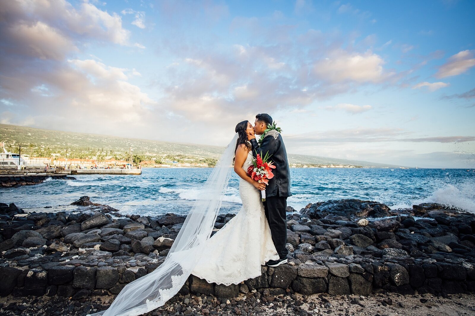 couple kissing against vibrant sunset wedding pn the Big Island