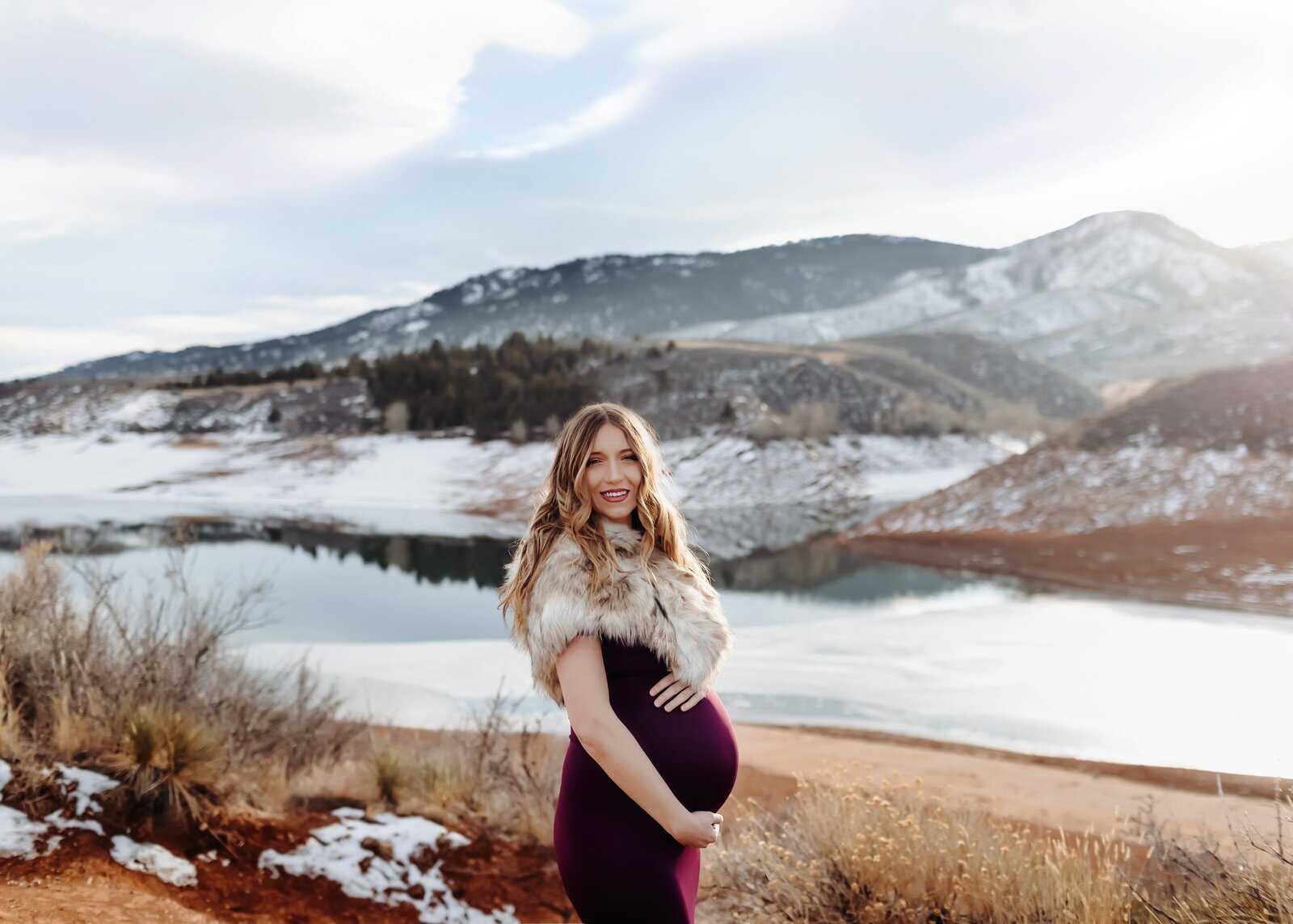 snowy mountain photoshoot with couple expecting their first baby