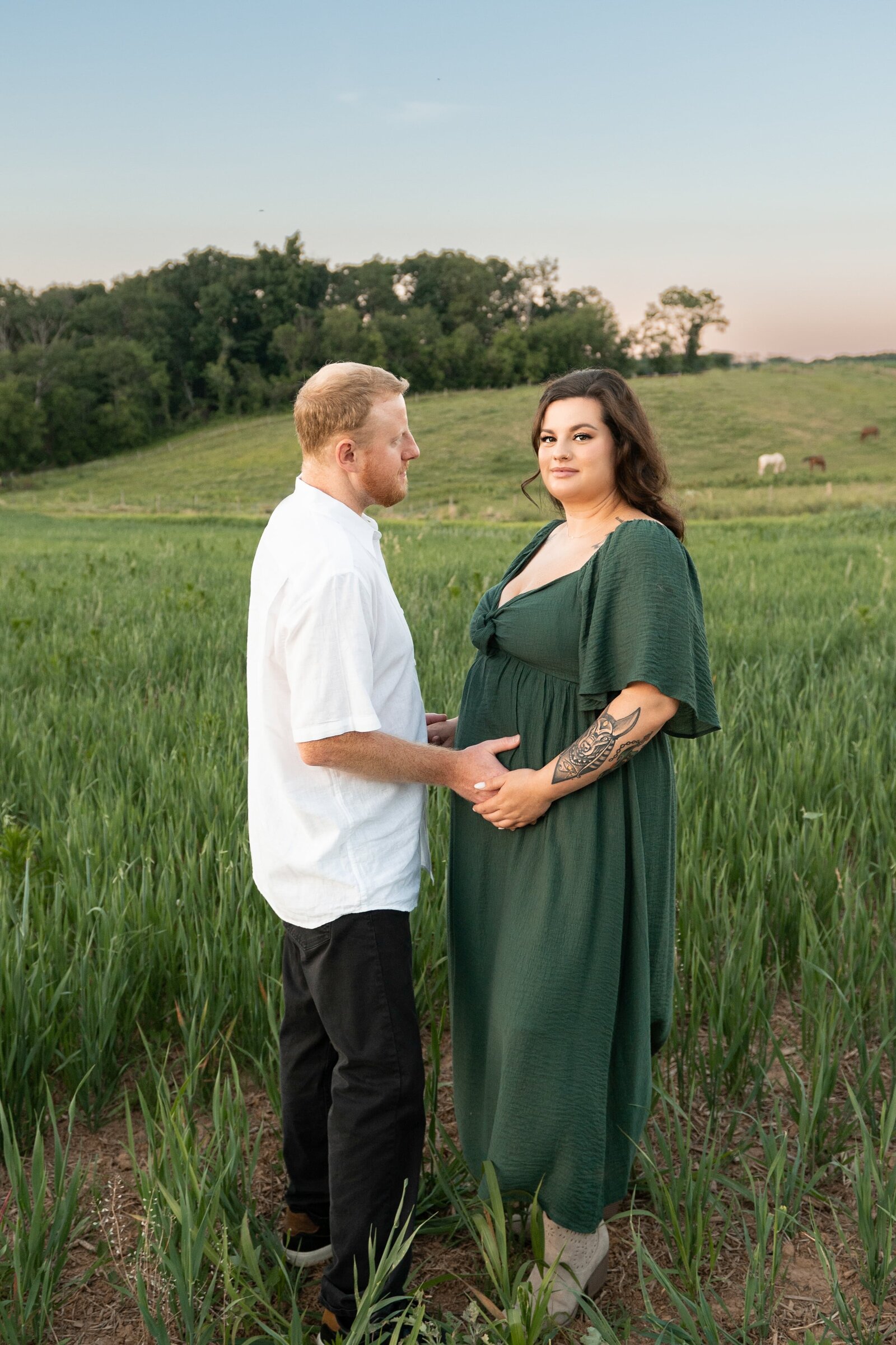 husband and pregnant wife at a horse farm for a maternity photoshoot