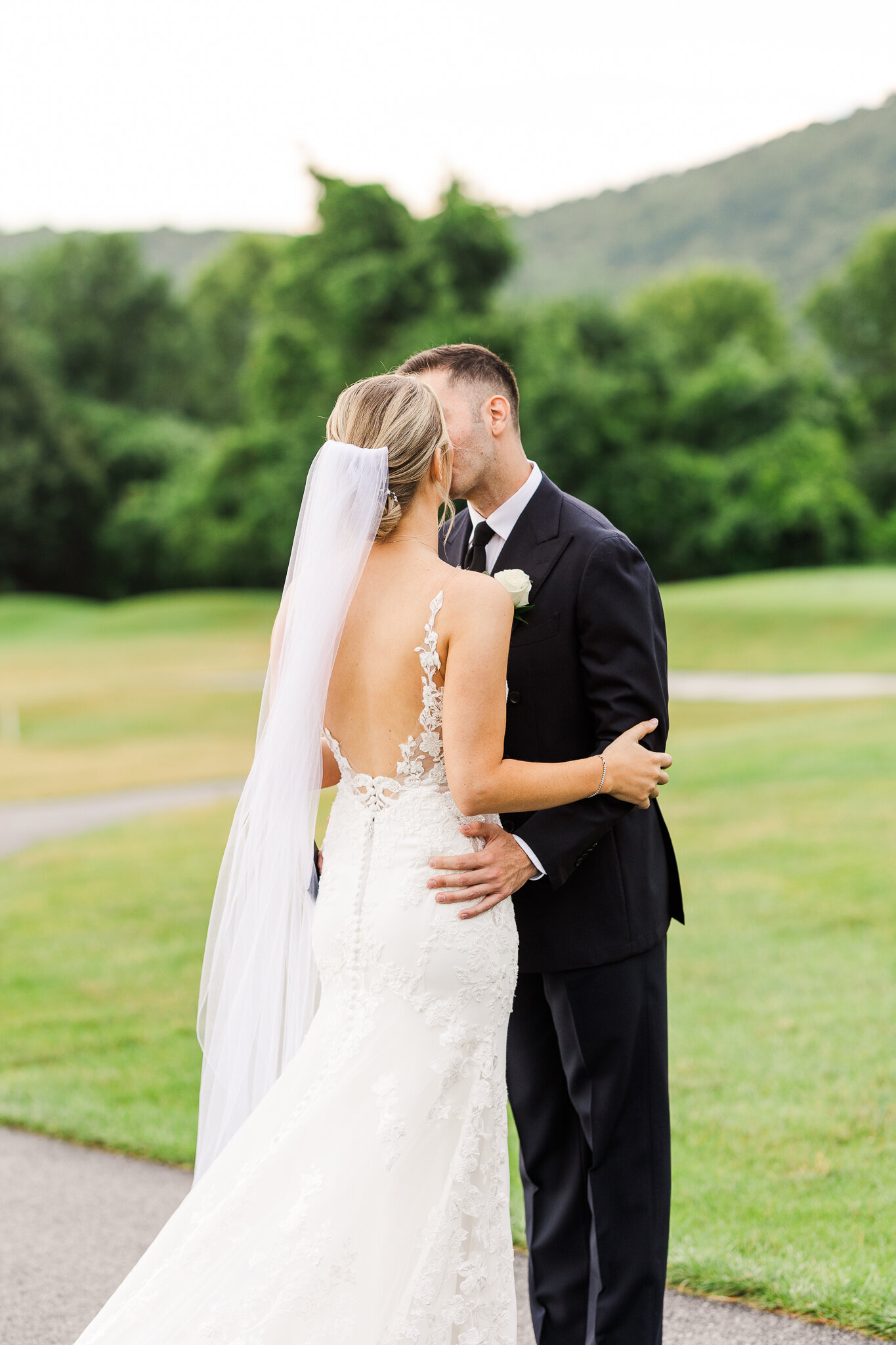 Romantic moment shared between bride and groom during portraits at SkyView Golf Club