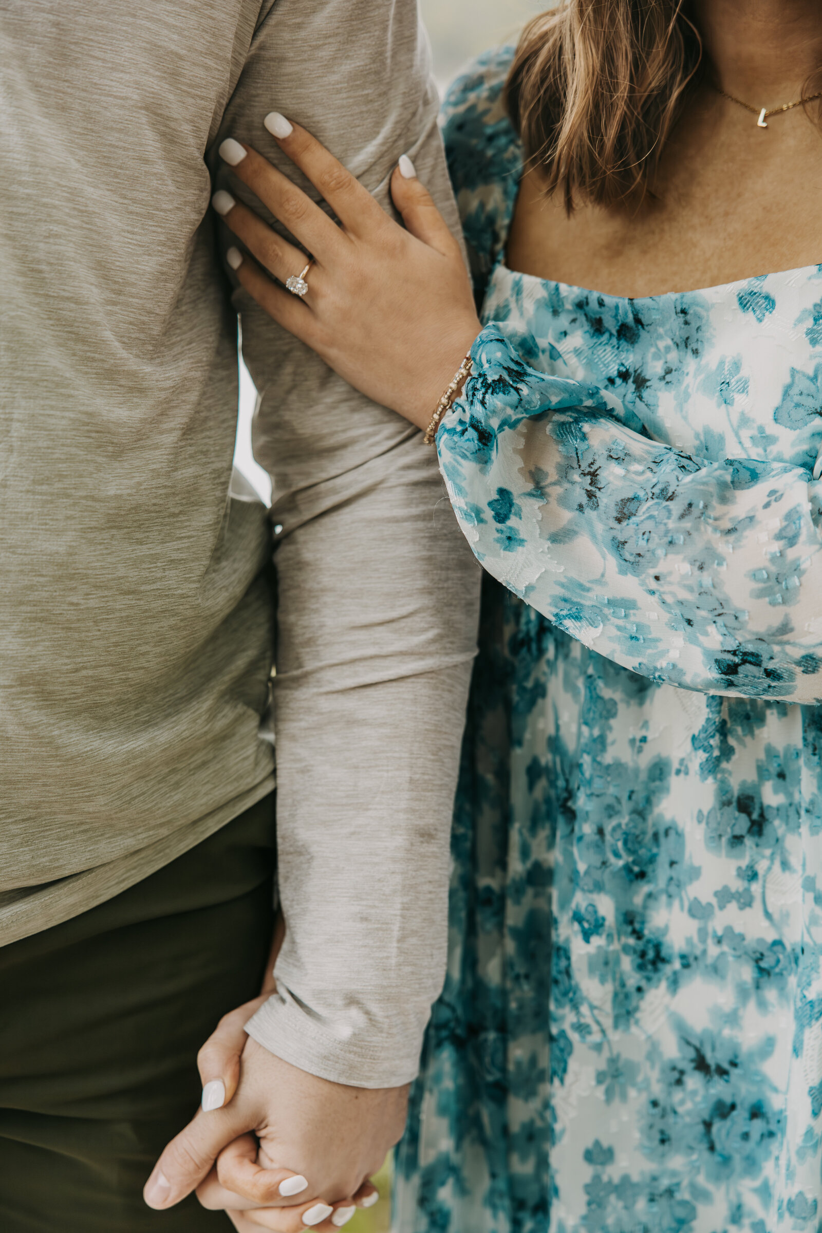 Engagement session with Drake and Lauren at Shelby Farms, close-up of them holding hands, with a focus on Lauren's engagement ring.