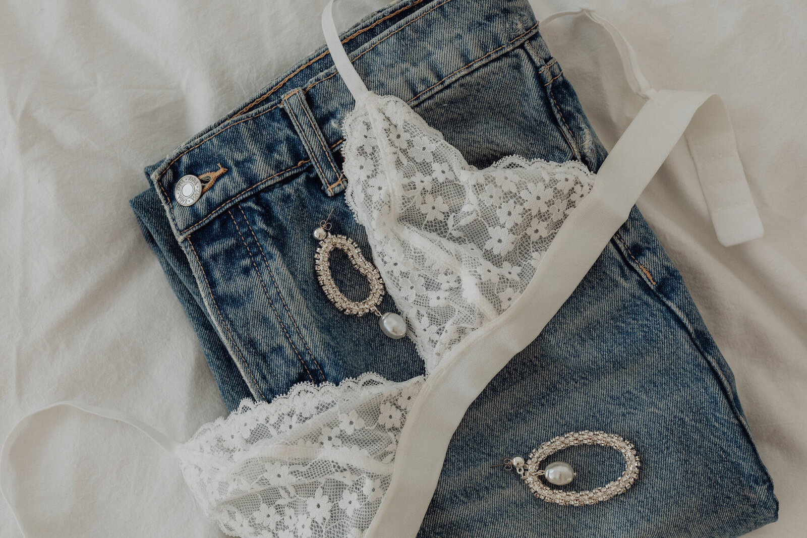 kaboompics_white-lace-triangle-top-jeans-silver-earrings-with-cubic-zirconia-and-pearl-31754