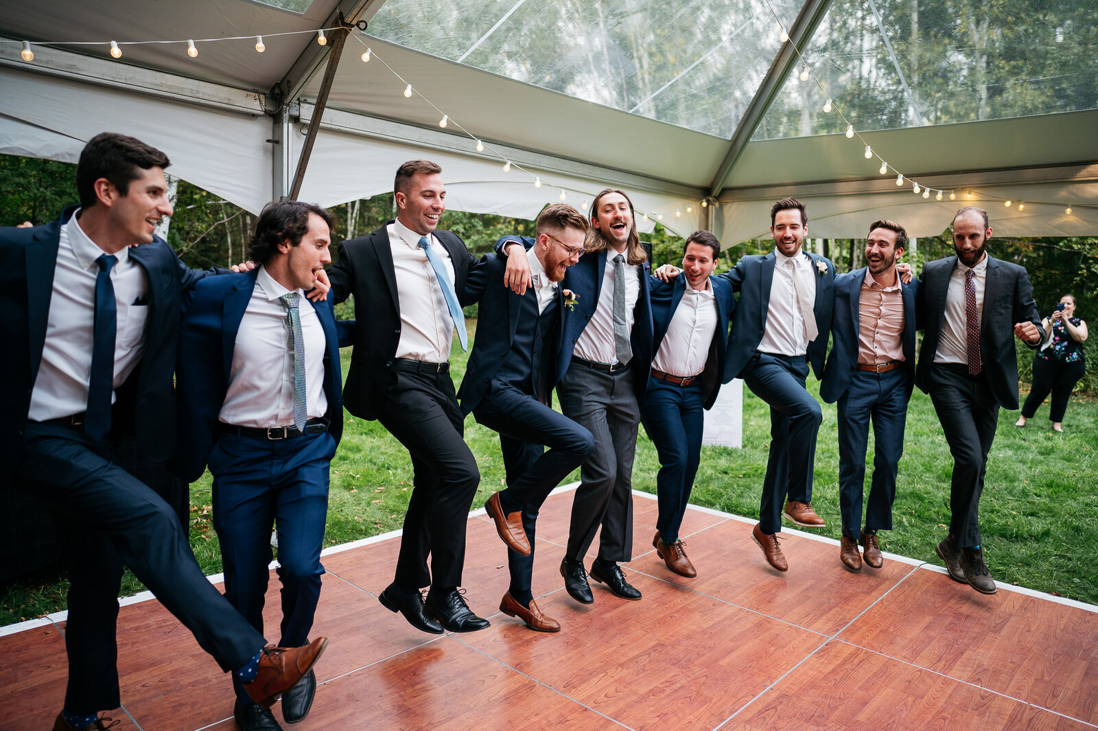 groom-groomsmen-dancing-dance-floor-tent-wedding