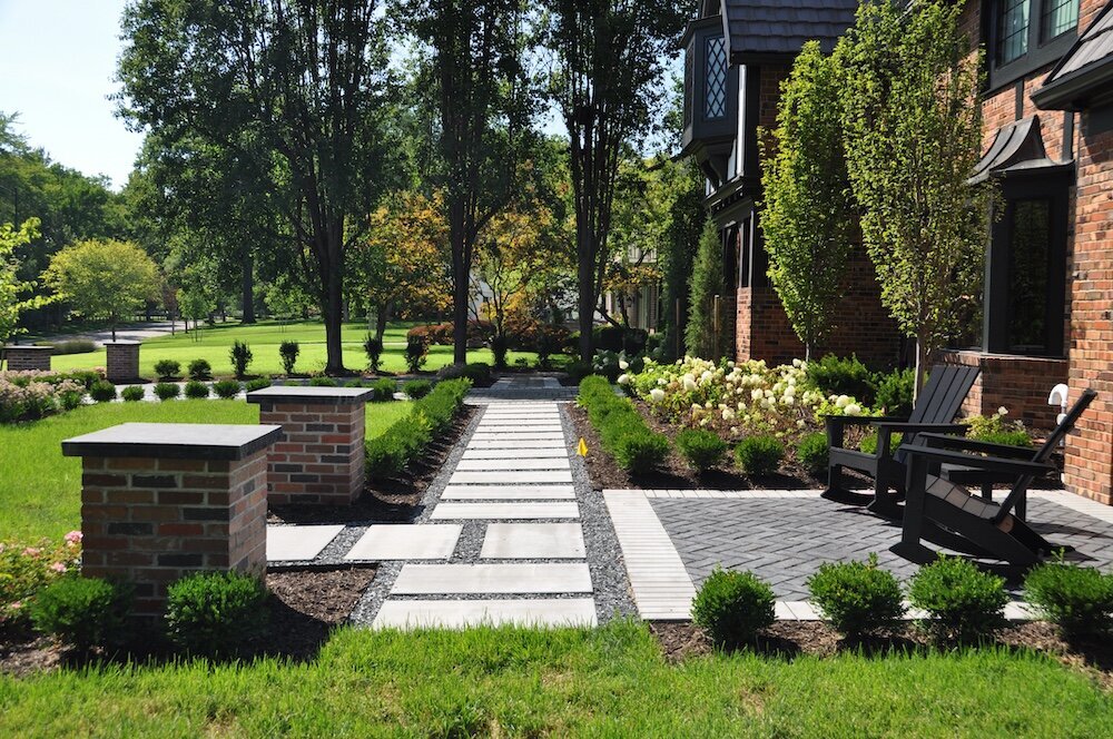 Landscape company project: a residential home with flowers, shrubs and stonework