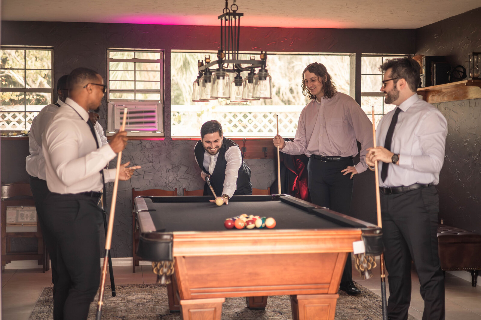 groom party playing pool in groom suite
