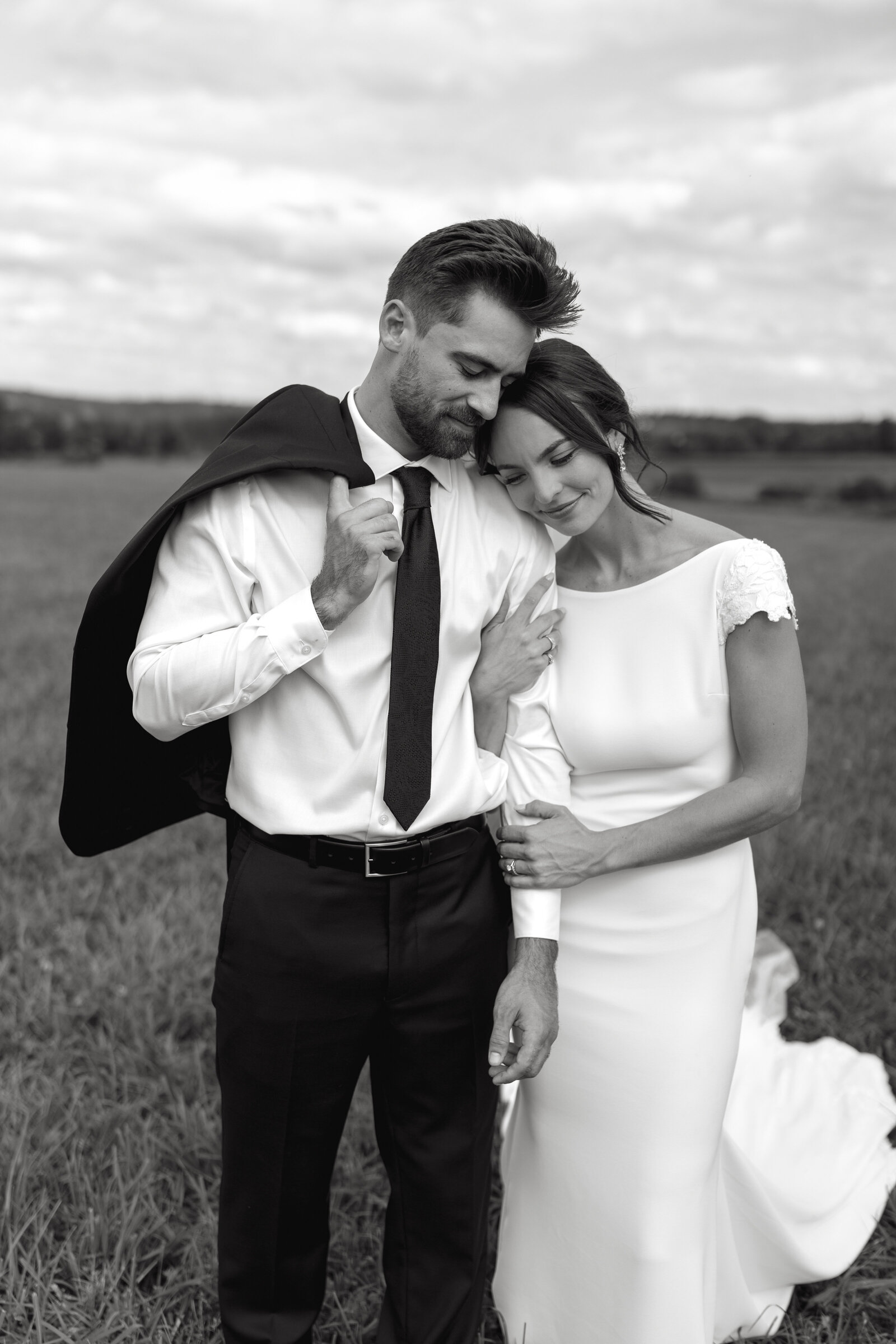 A couple poses for their bridal portraits after getting married at the Clover Barn in Nova Scotia. 