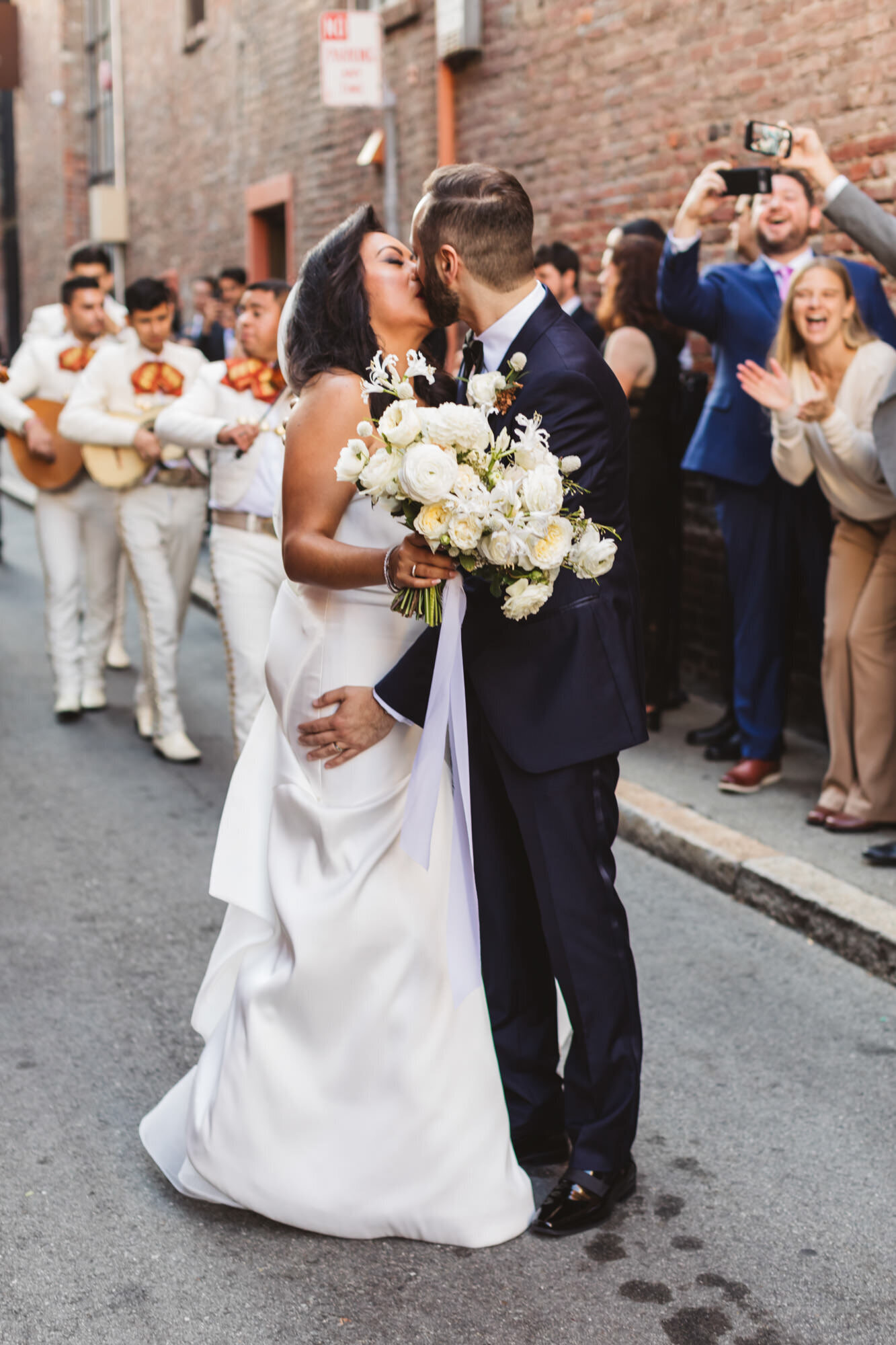 couple serenaded by mariachi band on wedding day