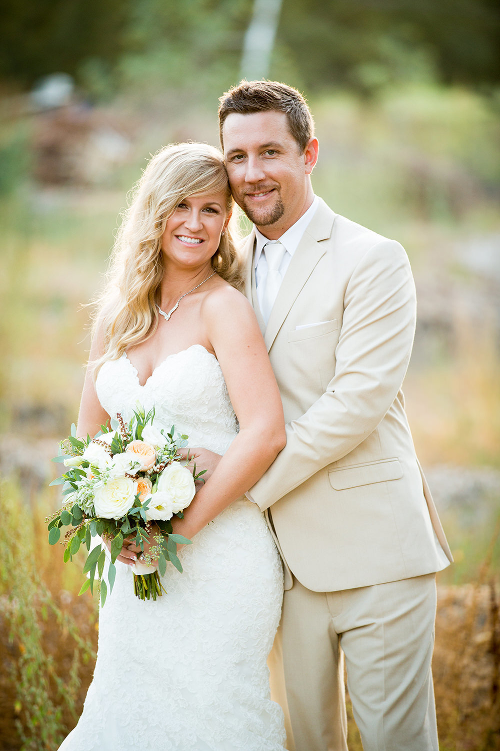 bride and groom smiling at camera