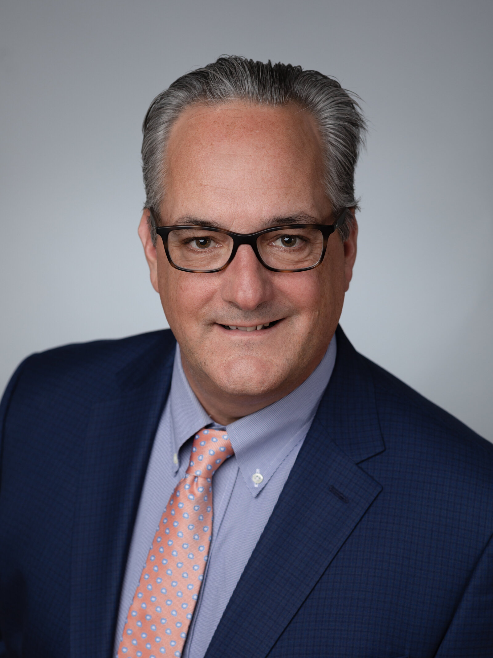 male headshot in blue suit