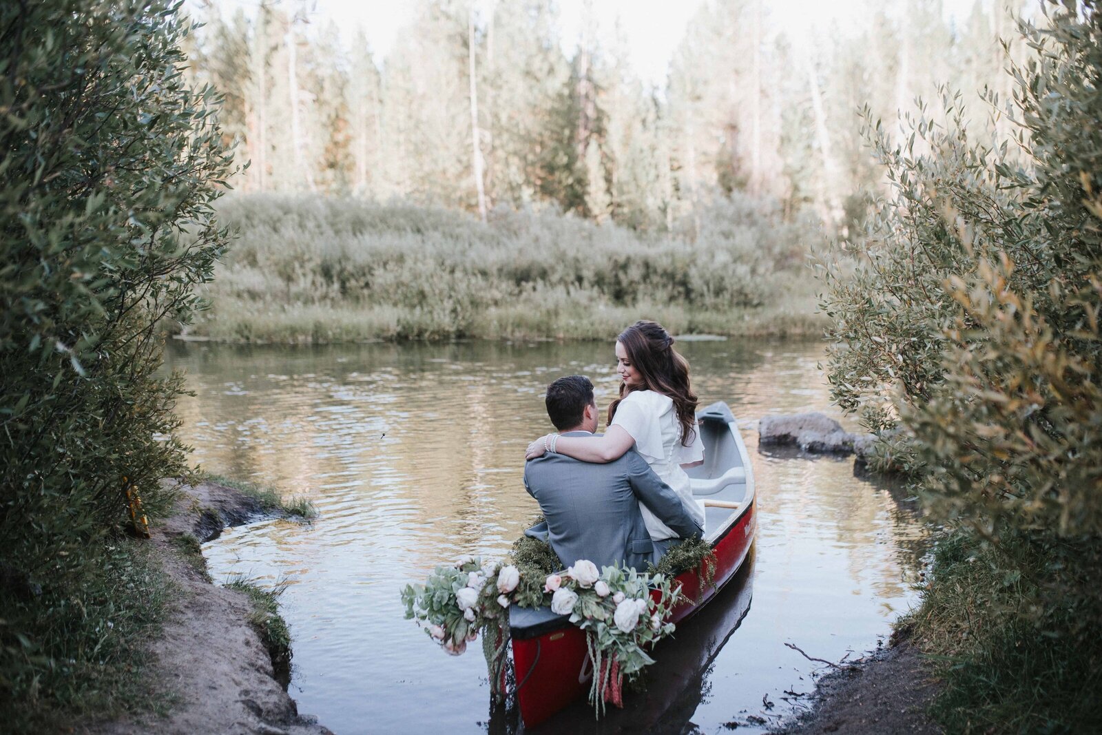 Lake Tahoe wedding photographer captures  bride and groom on canoe during outdoor bridal portraits in Lake Tahoe