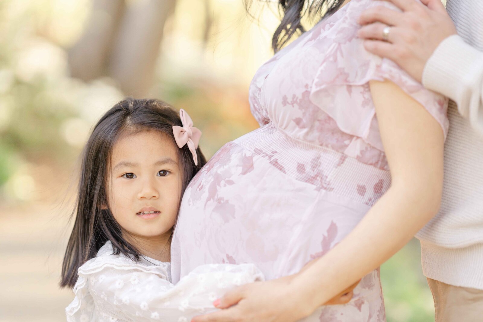 big sister hugging mom’s belly during Ashburn, VA maternity session