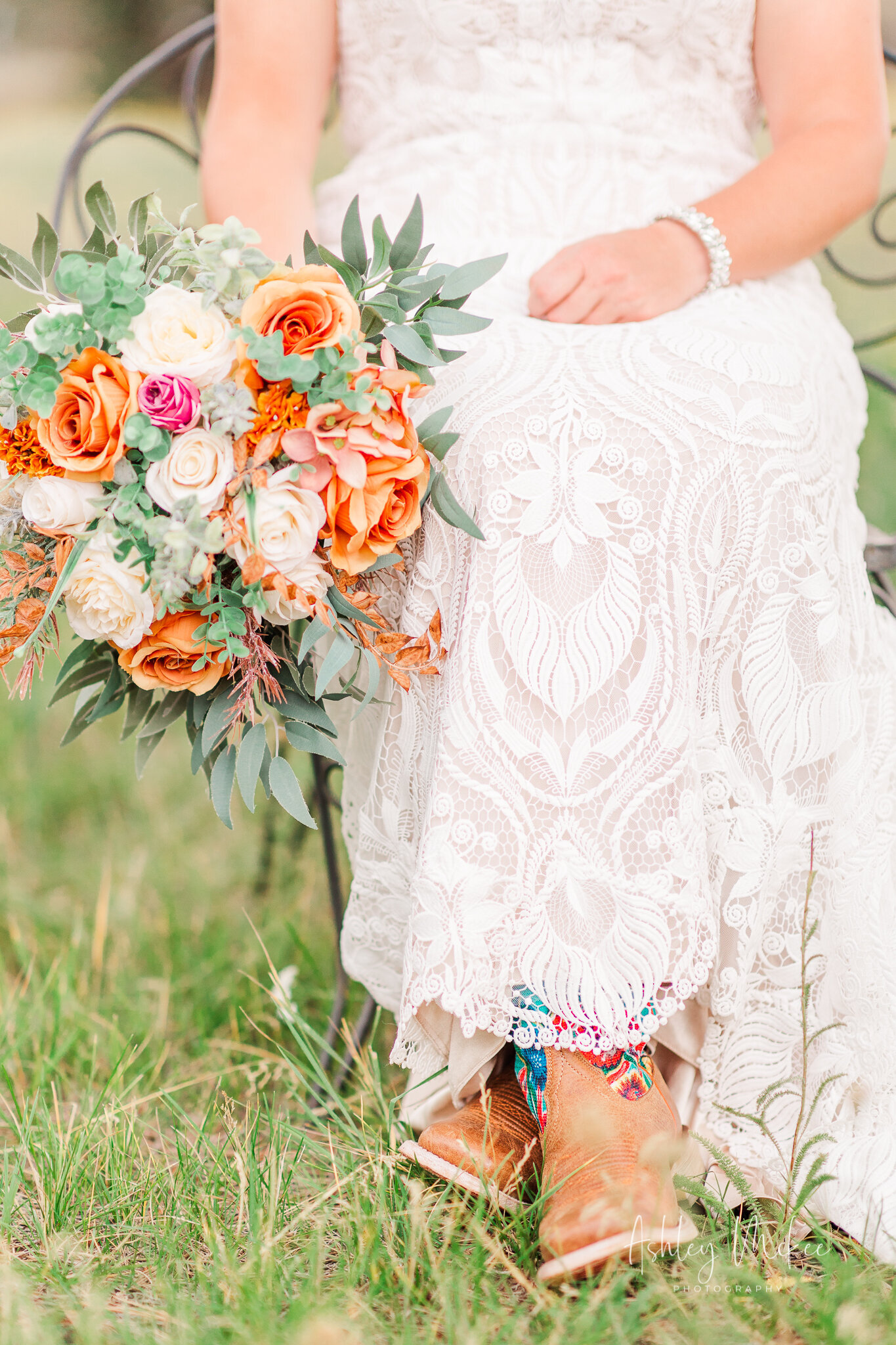colorful cowgirl boots, lace dress, bouquet