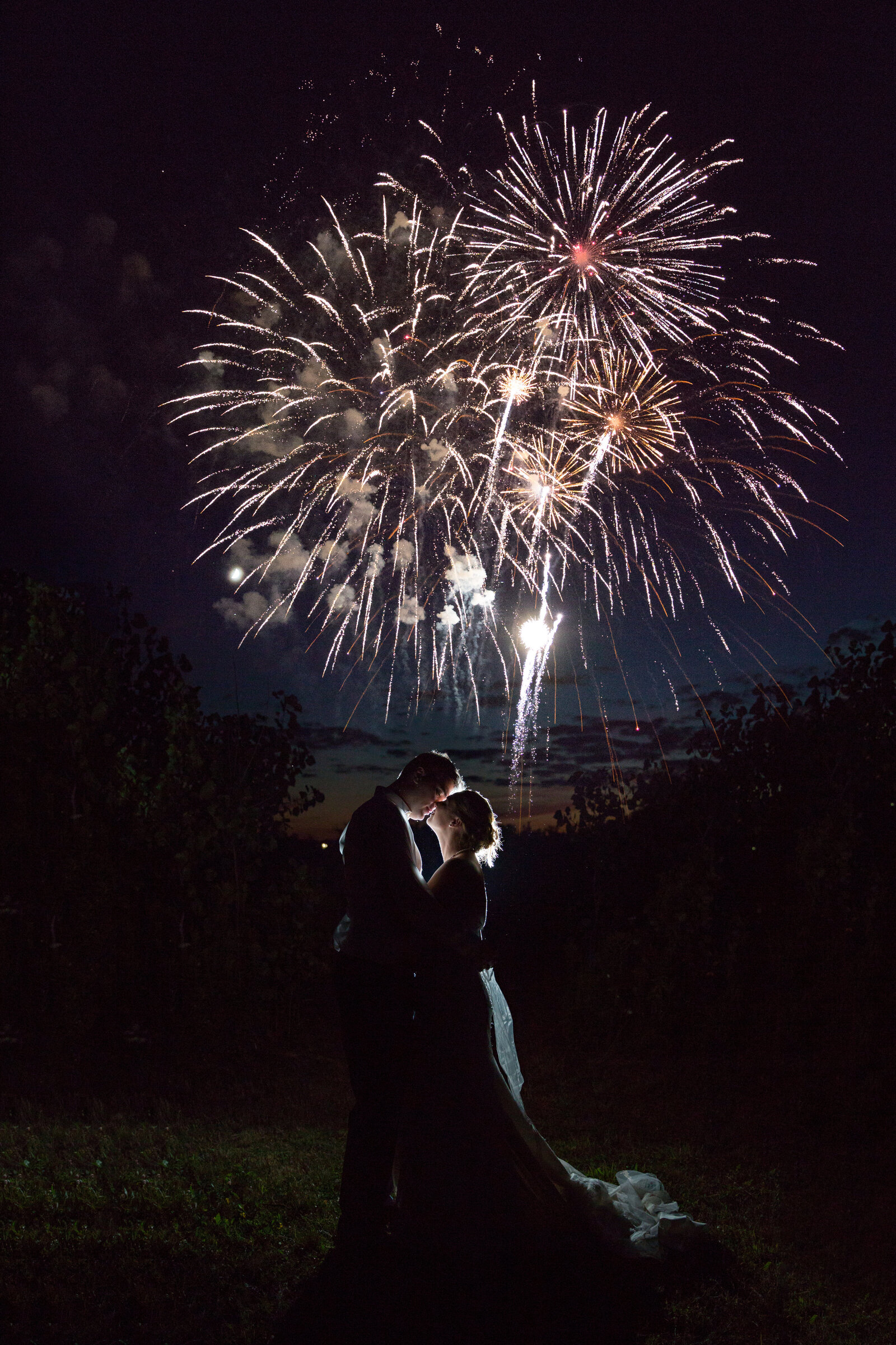 bride and groom at night with fireworks