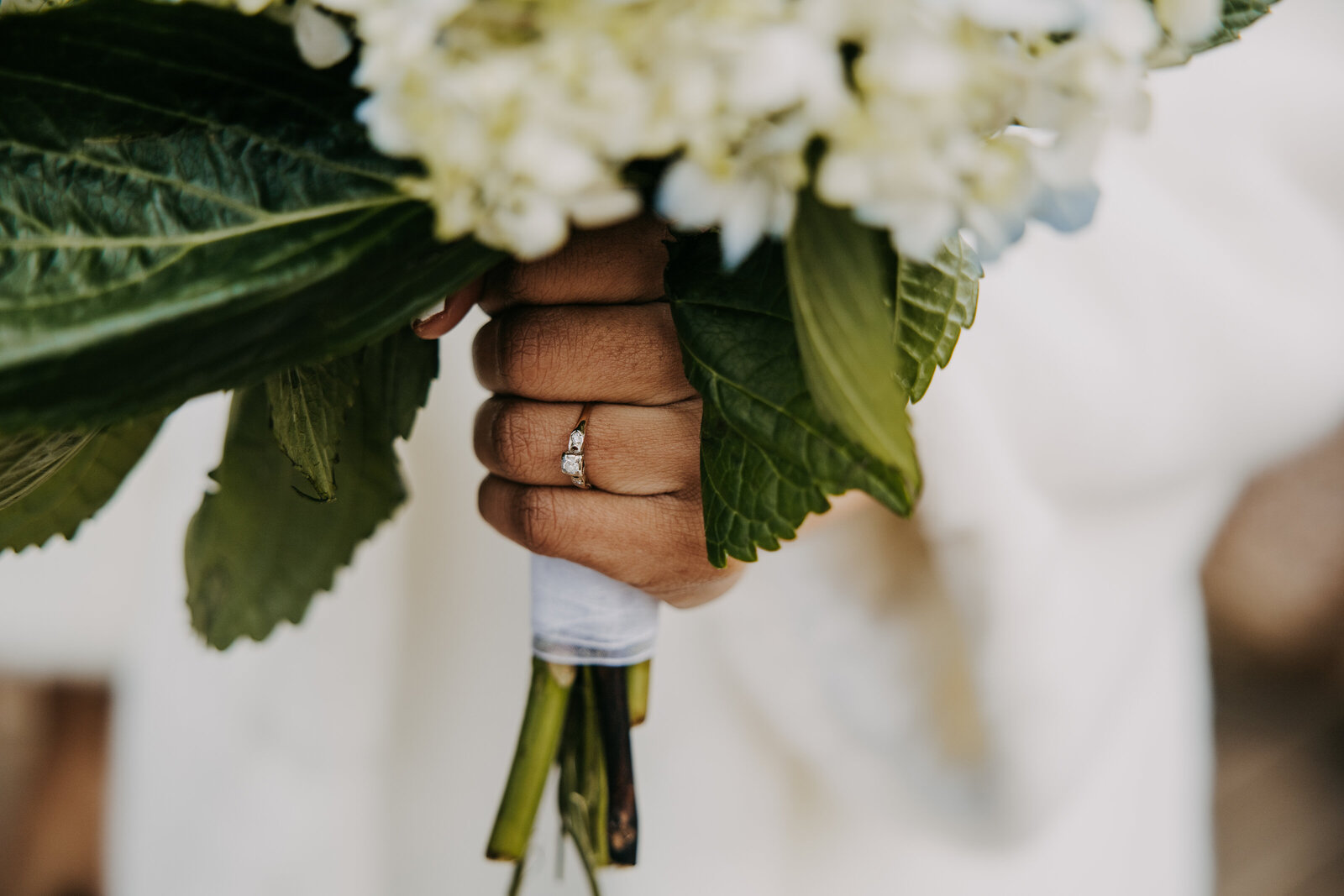 Wedding at Kincaid Manor, close-up of a bride holding her bridal bouquet, with focus on her engagement ring.