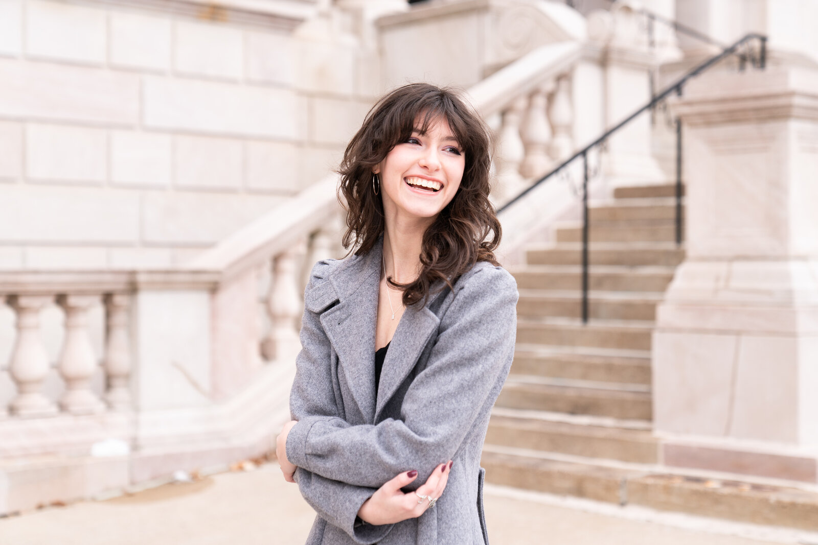 Senior girl stands in front of the Saint Paul Public Library during her senior photo session.