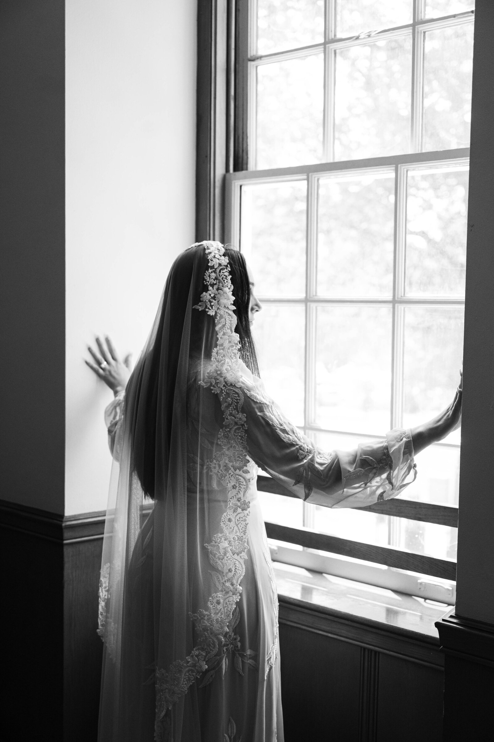 Bride staring out the window moments before the ceremony in Boston Massachusetts