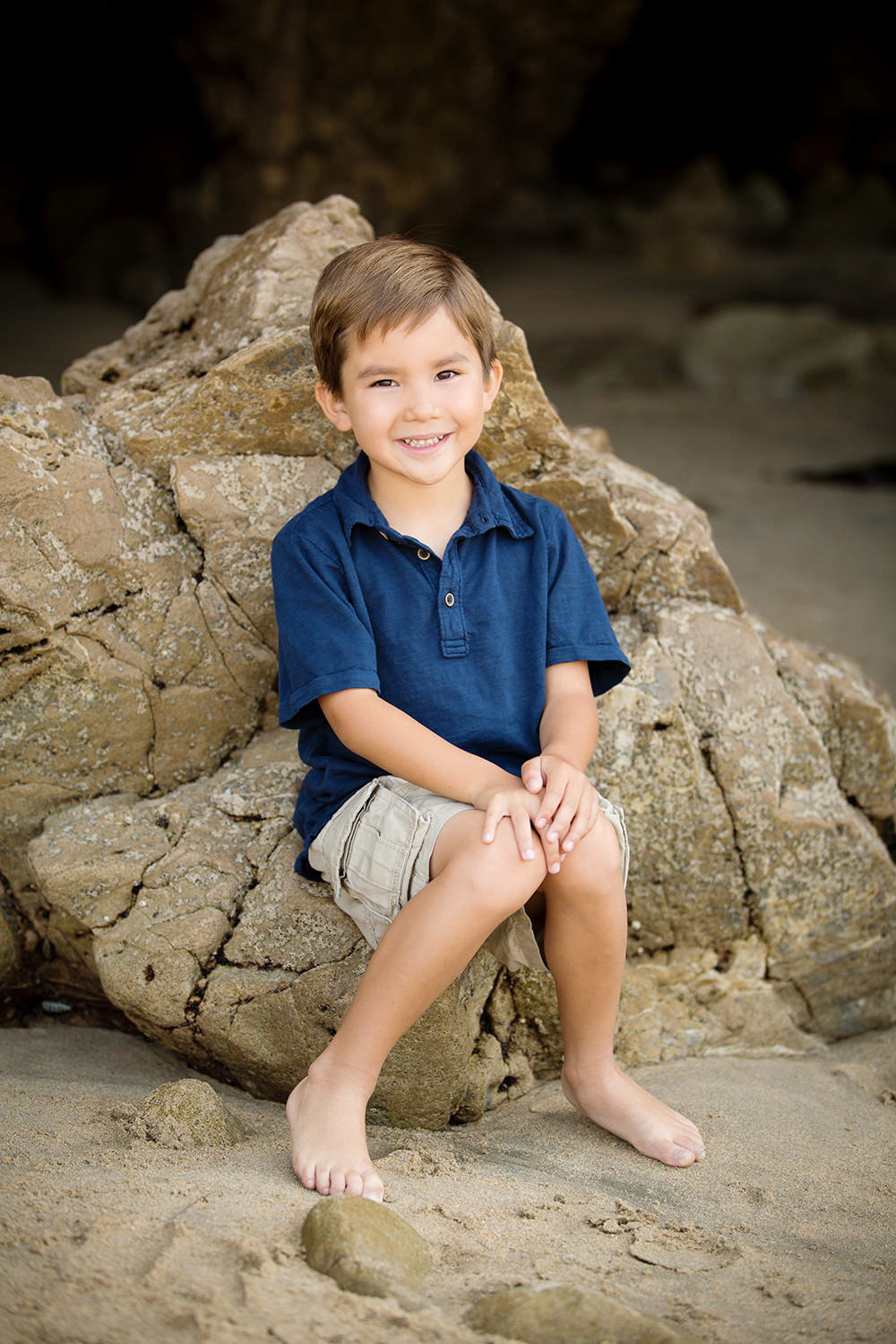 san diego family photographer | little boy in blue shirt at the beach sitting on rocks