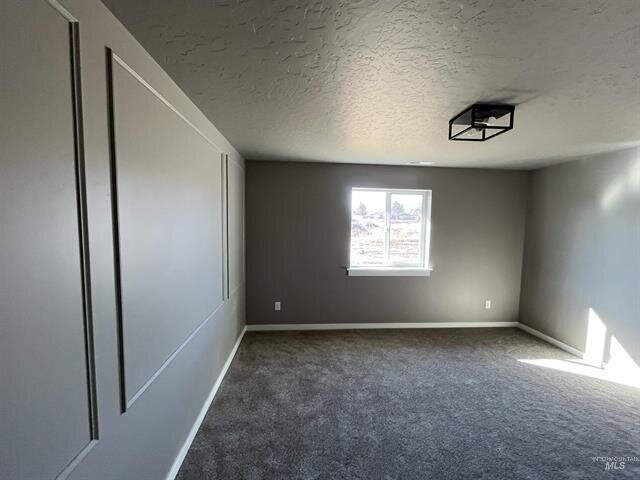 empty bedroom painted gray with gray carpet