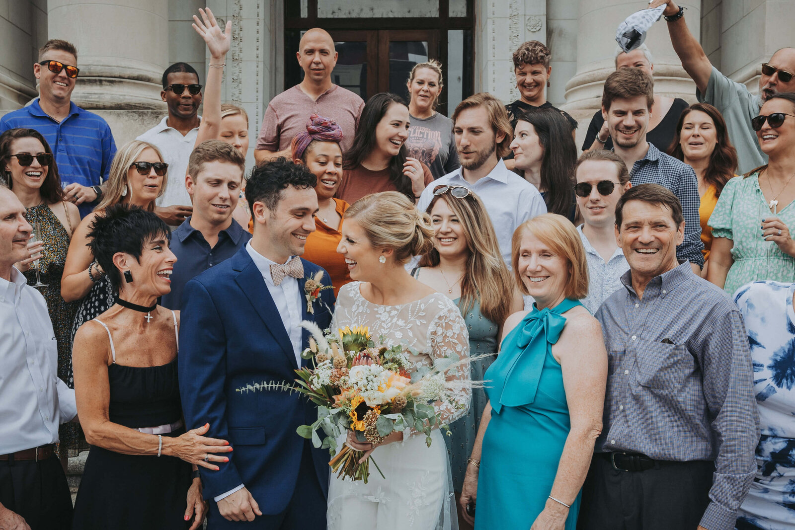 Laughter in a group photo after an intimate wedding