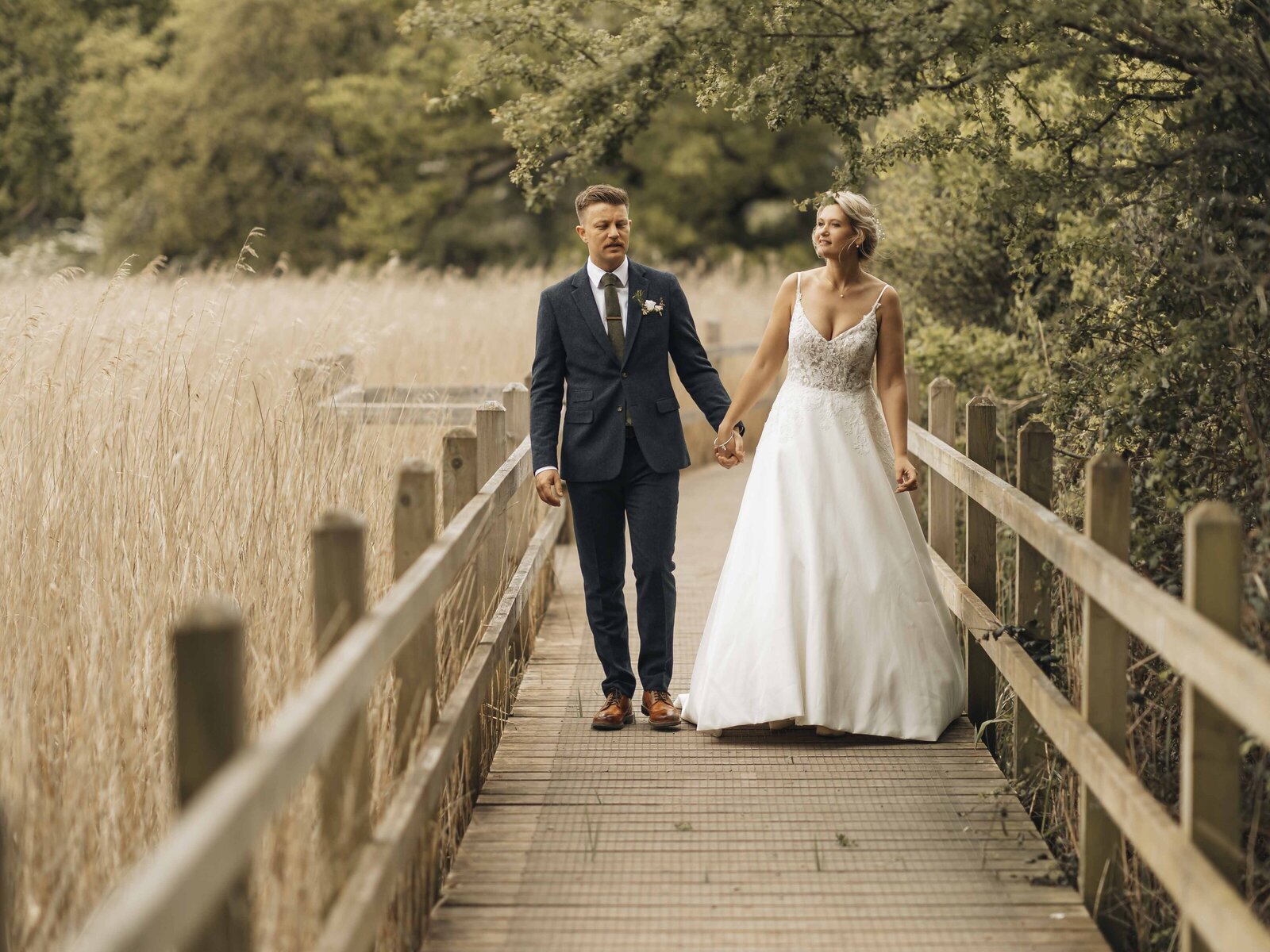 bride and groom strolling holding hands