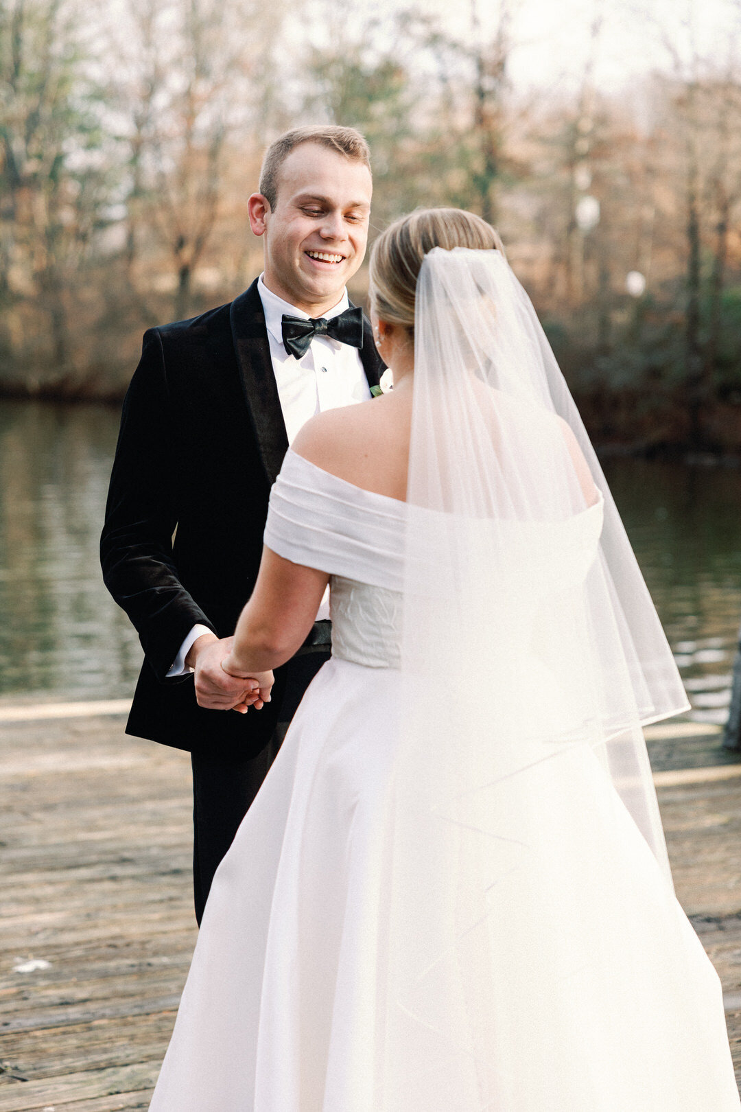 Groom Smiling at Bride at First look in Piedmont Park in Atlanta