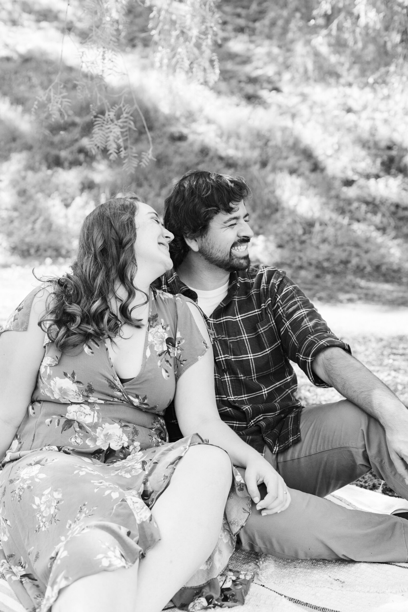 An engaged couple poses for photos in a garden in Los Angeles, Ca.