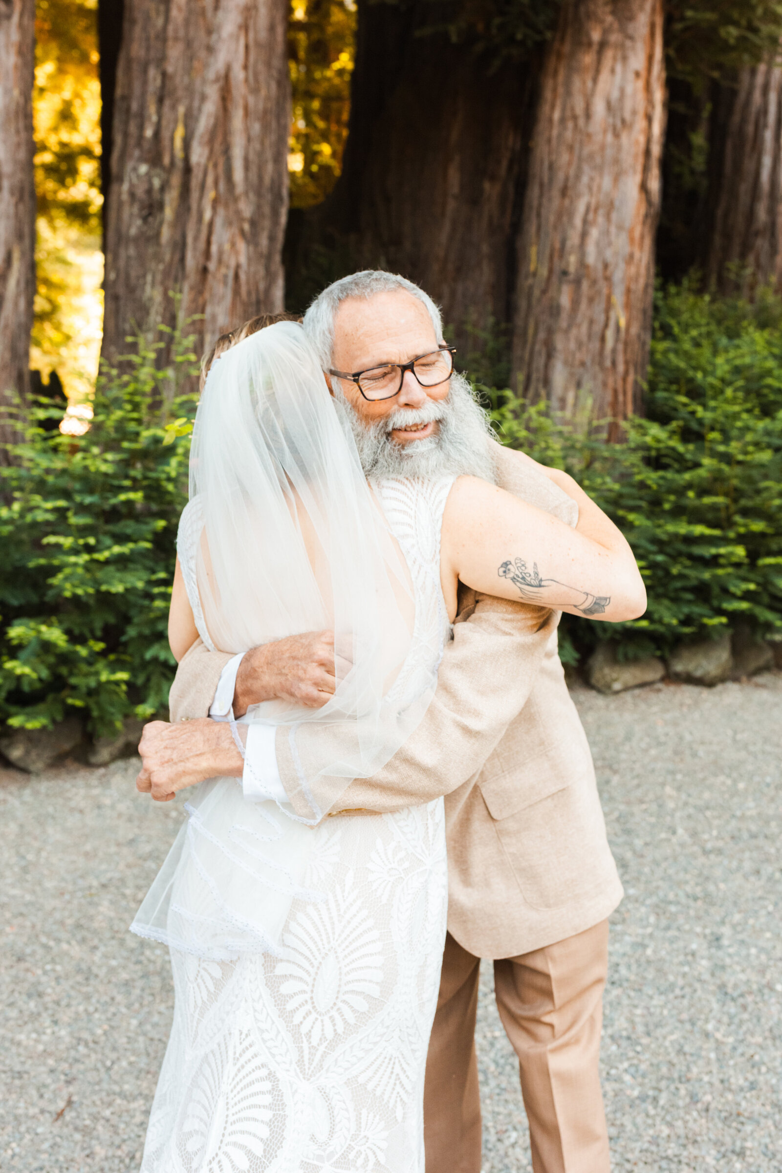 Bride and her father at her wedding in Santa Cruz, California in the redwood trees.