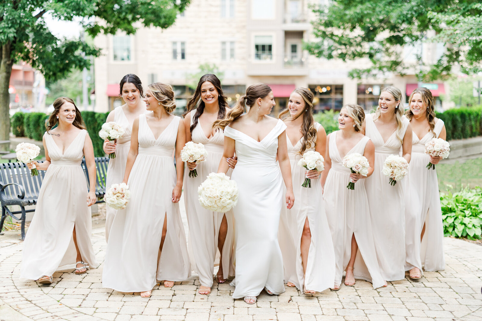 Bride walking and laughing with her bridesmaids