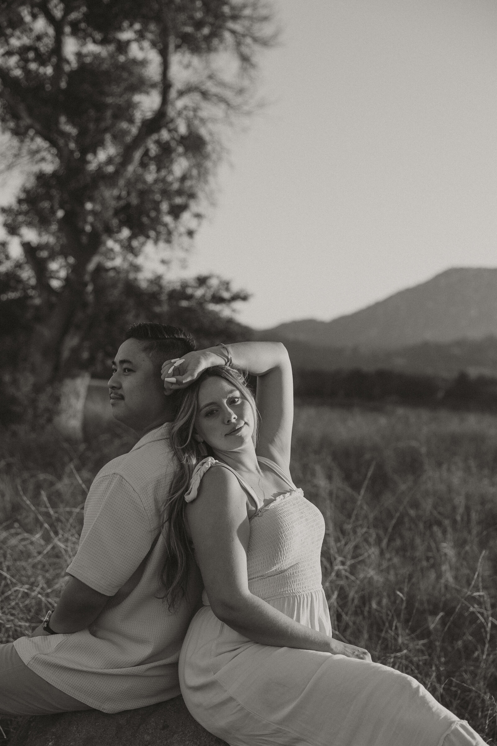 ramona grasslands engagement session, couple sitting on a rock, 