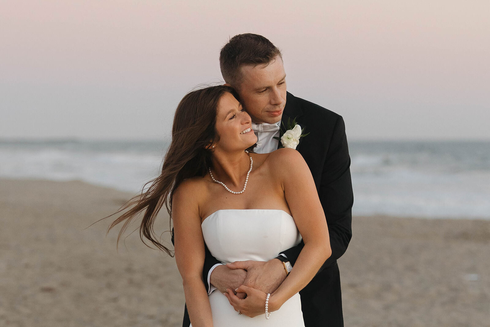 Bride and groom on the beach at sunset