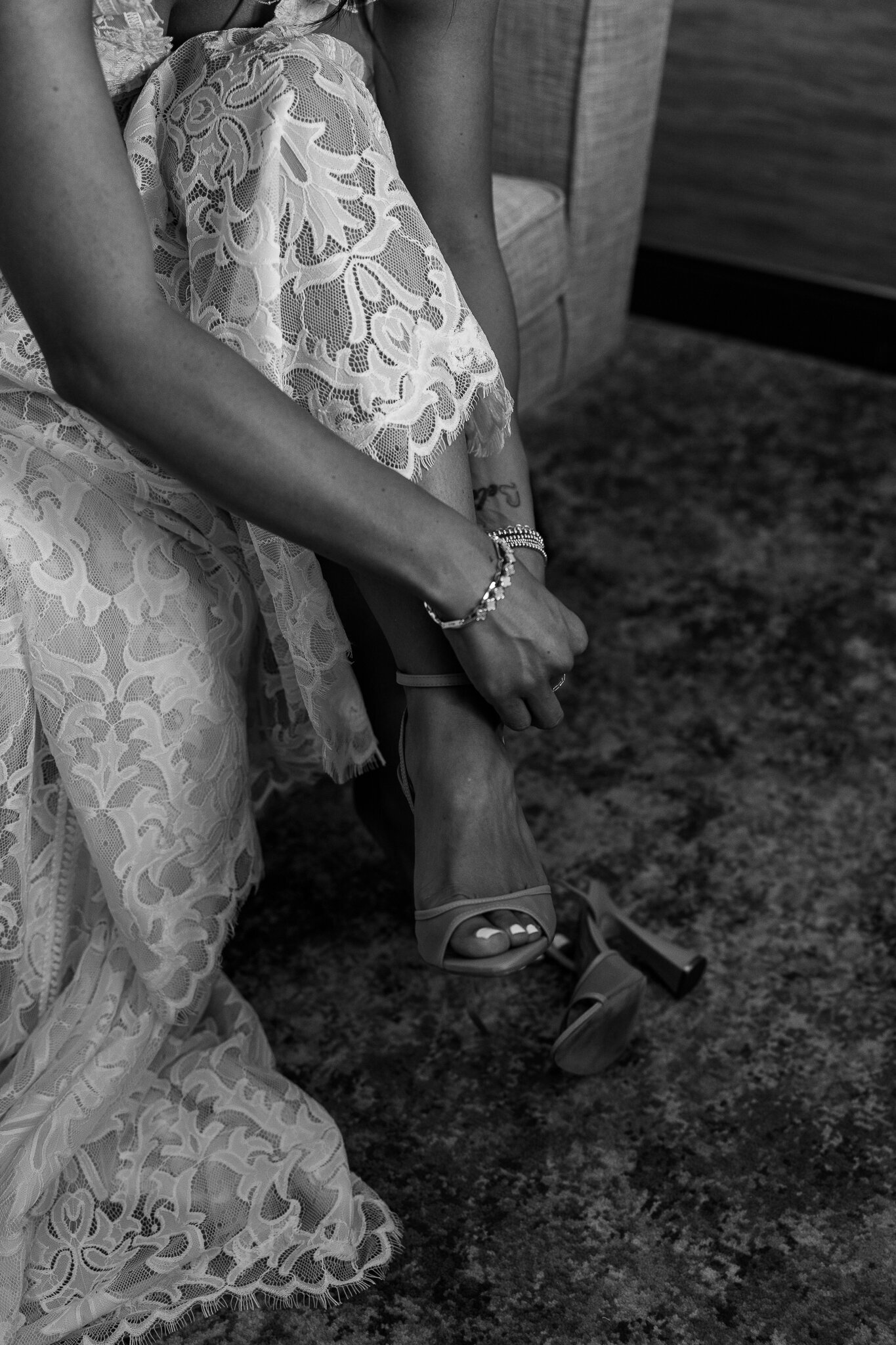 Bride putting on her shoes black and white image - Utah Wedding