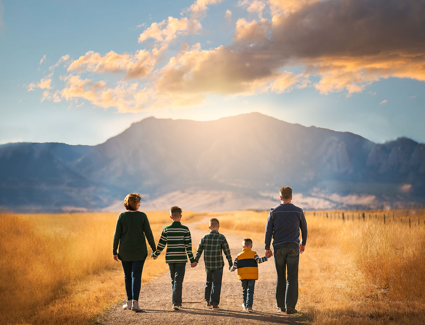 boulder-family-photographer-flatirons-landscape-view-sunset-colorado-sky-family-walking-holding-hands