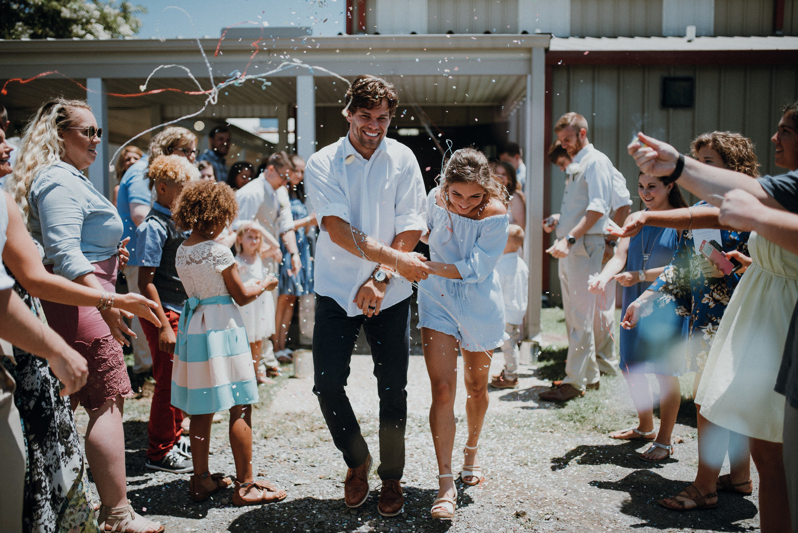 Bride and Groom run through their confetti exit at their Arkansas Wedding