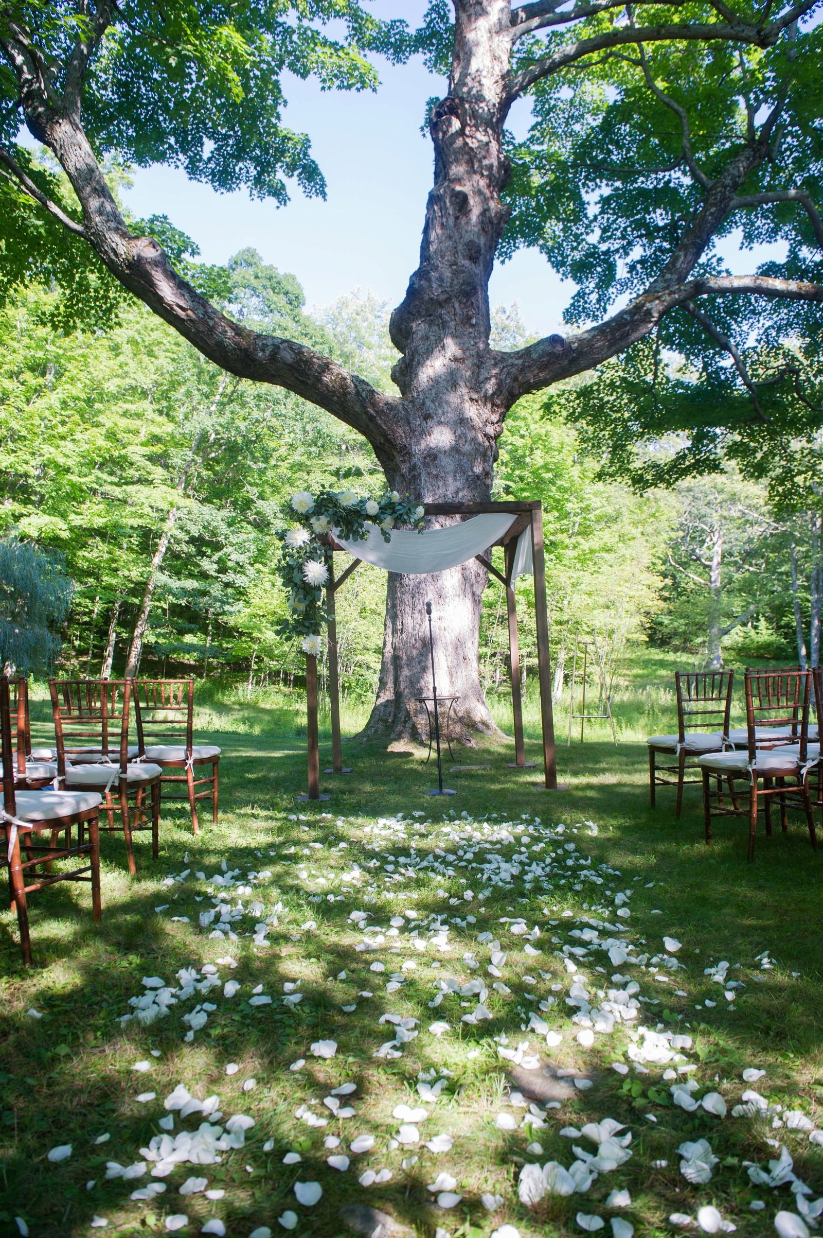 Gorgeous outdoor home wedding ceremony with white chuppah in Washington, CT