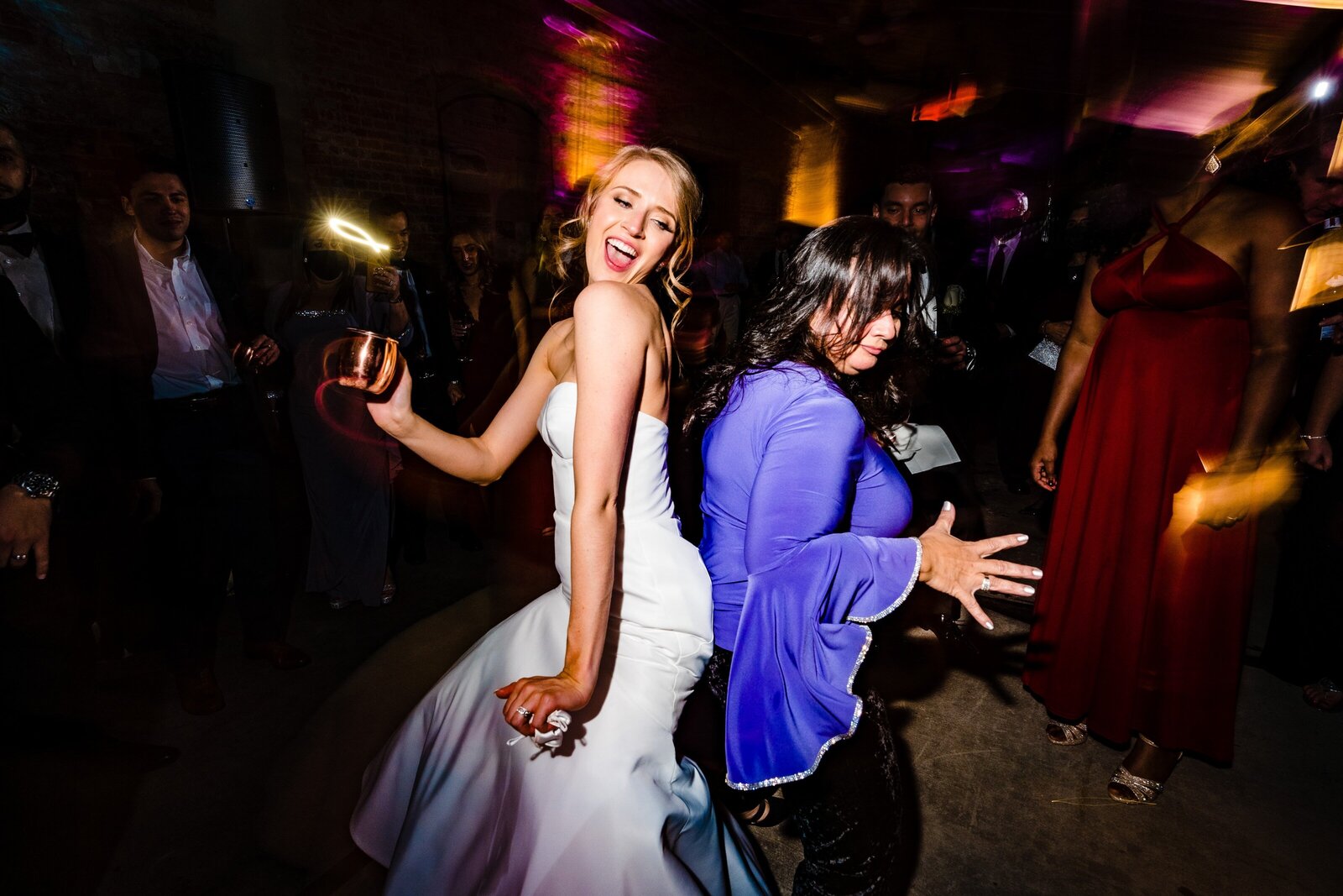 bride dances with the mother of the groom