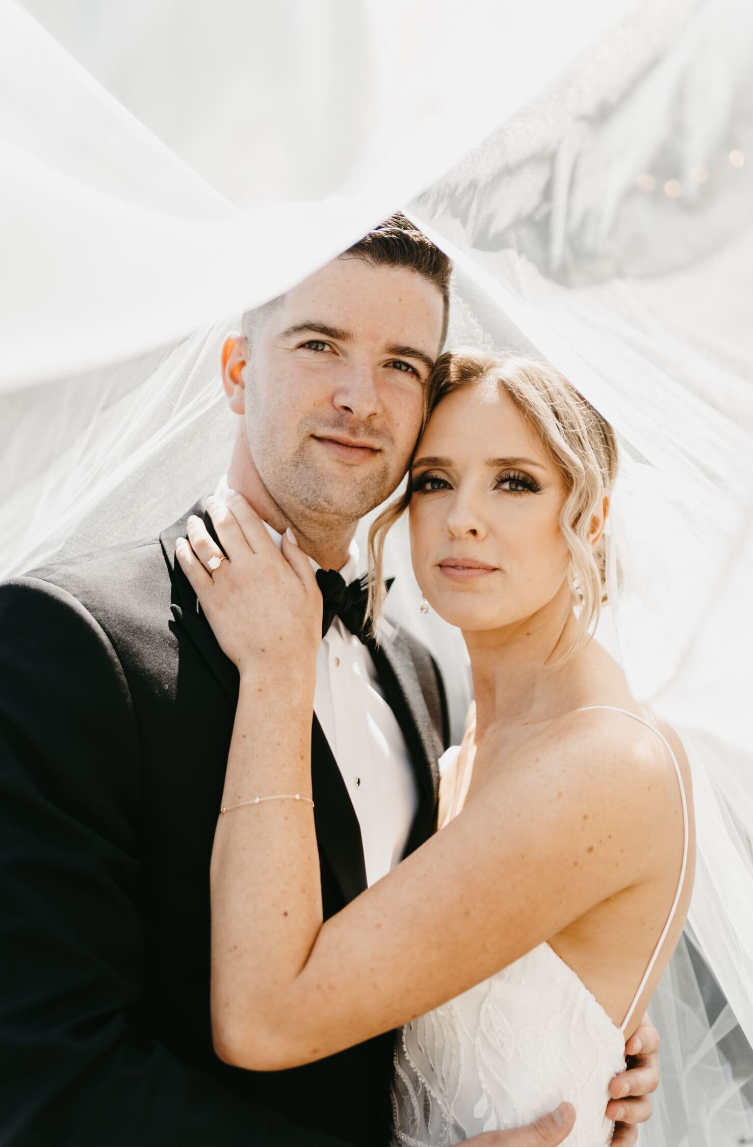 couple-looking-under-veil-home