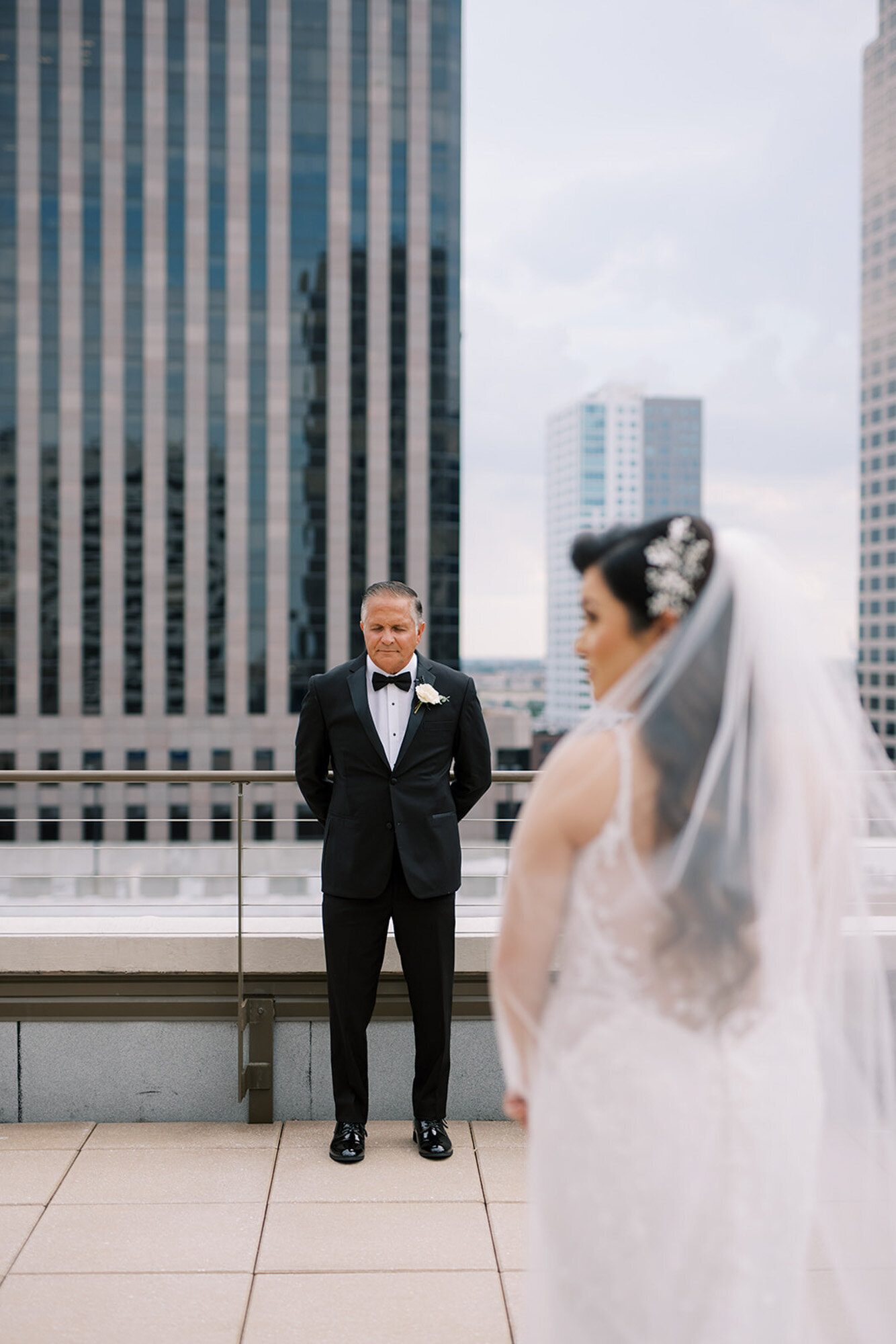 bride and groom standing on a rooftop