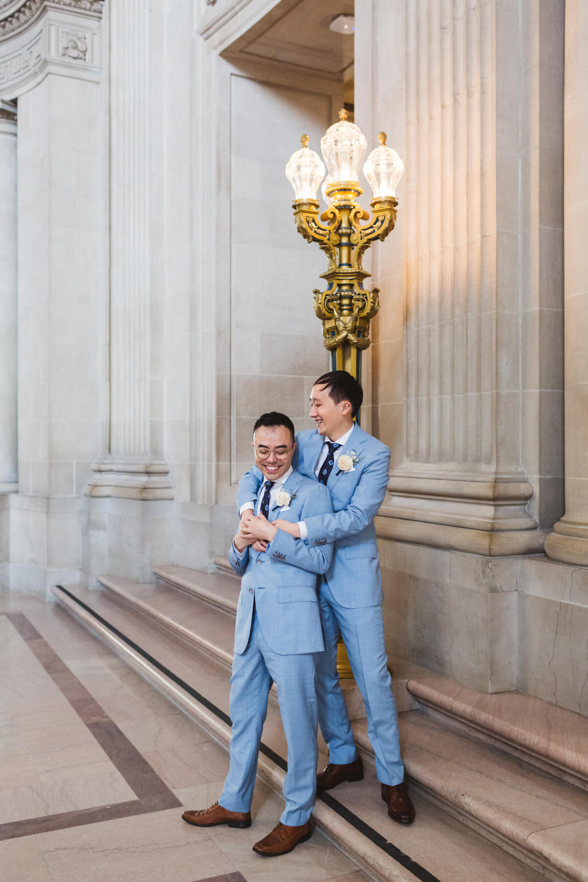 LBGTQ+ male couple in matching suits at San Francisco City Hall wedding